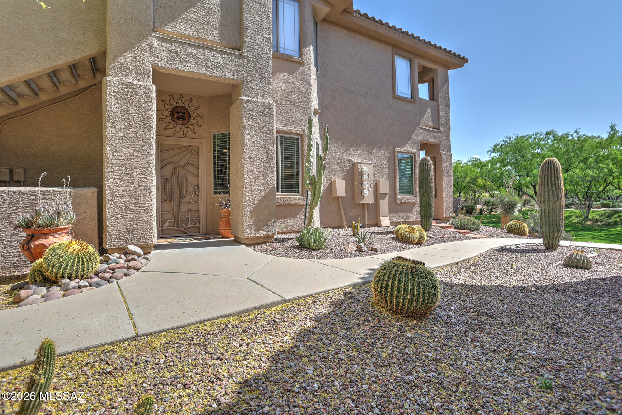 AirBnb OK. Beautifully remodeled 2bed, 2bath 1st floor condo located within the Vistoso Trail Nature Preserve. This home features a desirable split bedroom floor plan and hard surface flooring throughout. The upgraded kitchen offers granite countertops, stainless steel appliances, and ample cabinetry. Both bathrooms have been updated with granite countertops, upgraded vanities, and tiled walkin showers with bench seats, including a luxury dual vanity in the primary bathroom. The spacious primary suite includes a large walk-in closet. Enjoy a full laundry room with additional storage and pantry space, plus an attached garage. The upgraded flagstone rear patio backs to a lush grass area and in close proximity to the heated pool, spa, and recreation center. Newer water heater and windows