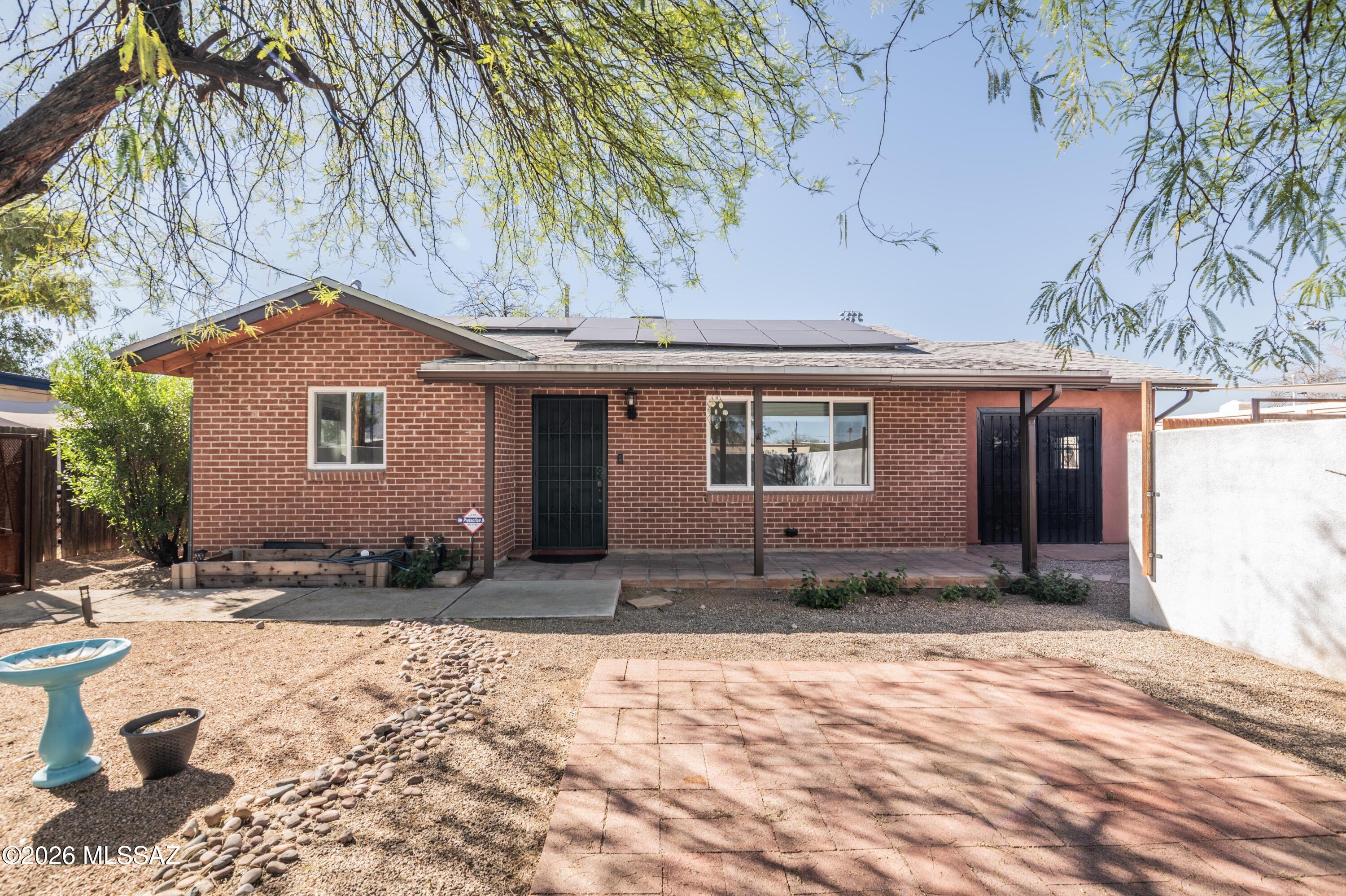 OWNED SOLAR! Beautifully upgraded 2-bedroom, 1-bath home with a versatile flex space ideal for an office/den, or art studio, featuring vaulted ceilings, its own mini split system, and a private entrance to the front and backyard. The updated kitchen offers granite countertops and a neutral backsplash, dual-pane windows and an owned solar system keep energy costs low, averaging about $30 per month. HVAC was installed in 2020.

Additional highlights include covered parking, covered patios, a large storage shed, fully tiled floors, a separate laundry room, ceiling fans, solar tubes, and ample parking. Spacious, private front and back yards offer plenty of room to relax or entertain. Centrally located near Banner UMC, the University of Arizona, and endless dining, shopping, and entertainment