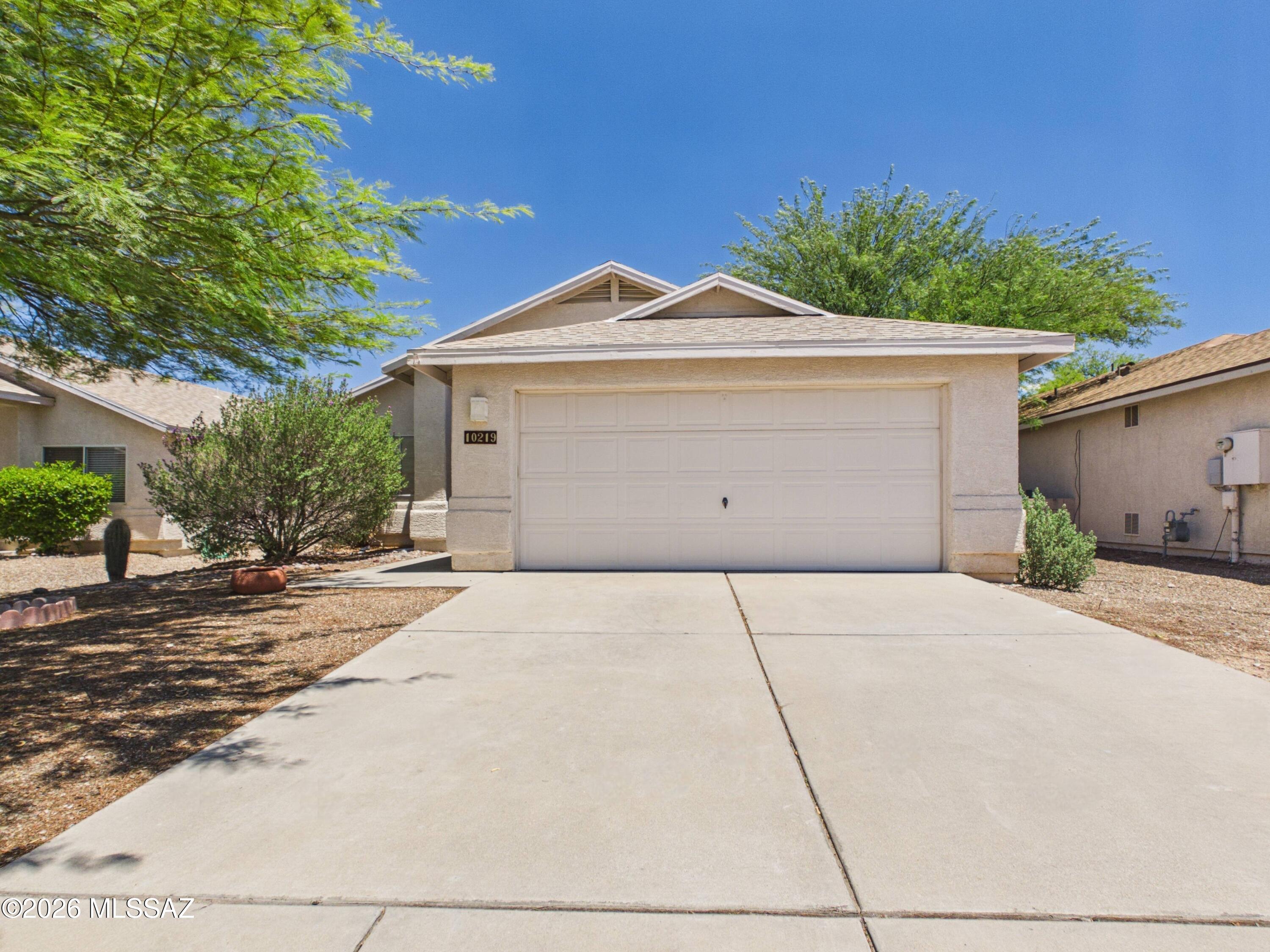 Welcome to this beautifully maintained single-story home in the desirable Rita Ranch community. Featuring 3 bedrooms, 2 bathrooms, and an inviting open-concept layout, this home offers comfortable living with abundant natural light throughout. The spacious kitchen includes ample cabinetry, generous counter space, and a breakfast bar that opens to the living and dining areas, making it ideal for entertaining. The primary suite features a walk-in closet and private bath, while the additional bedrooms offer flexibility for guests, a home office, or hobbies. Enjoy the covered patio and low-maintenance backyard, plus a 2-car garage. Conveniently located near parks, shopping, dining, and the highly acclaimed Vail School District.