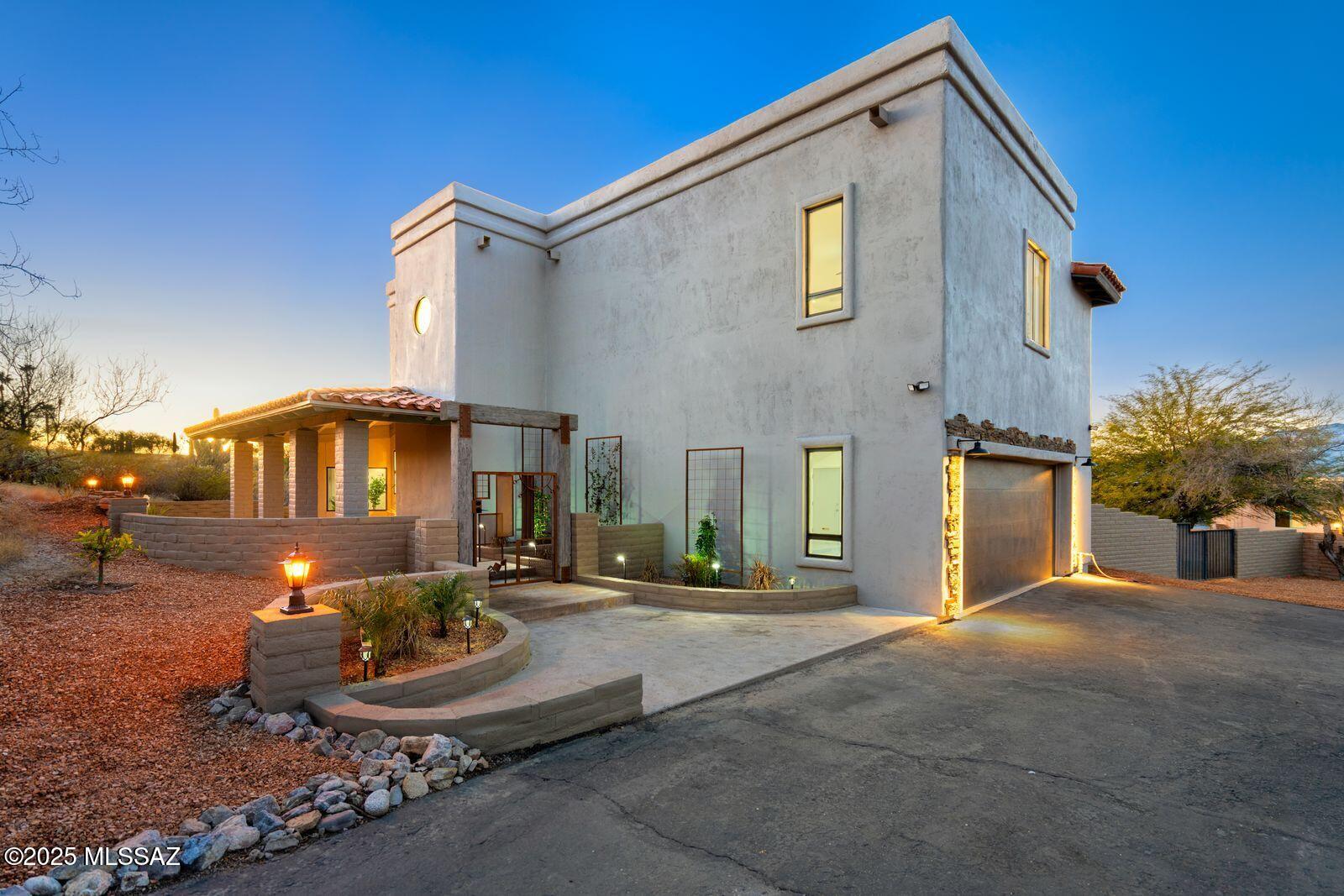 Beautifully updated custom home features superior craftmanship & fabulous finishes throughout set in a desirable, private neighborhood. Foyer opens to great room which showcases a dramatic stacked stone fireplace & stunning Catalina mountain views. Gourmet kitchen is invitingly open, ideal for entertaining. Formal dining off the kitchen as well. The split floor plan allows for numerous living options. Generous primary suite w/loft & two private balconies encompasses the upper level. You will love the luxurious primary bath featuring a soaking tub that overlooks more eyepopping views. Main level contains 4 additional bedrooms & 2 baths. Enjoy the raised patio deck & fully enclosed backyard ready for  your creative concepts. Garage EV hookup & more