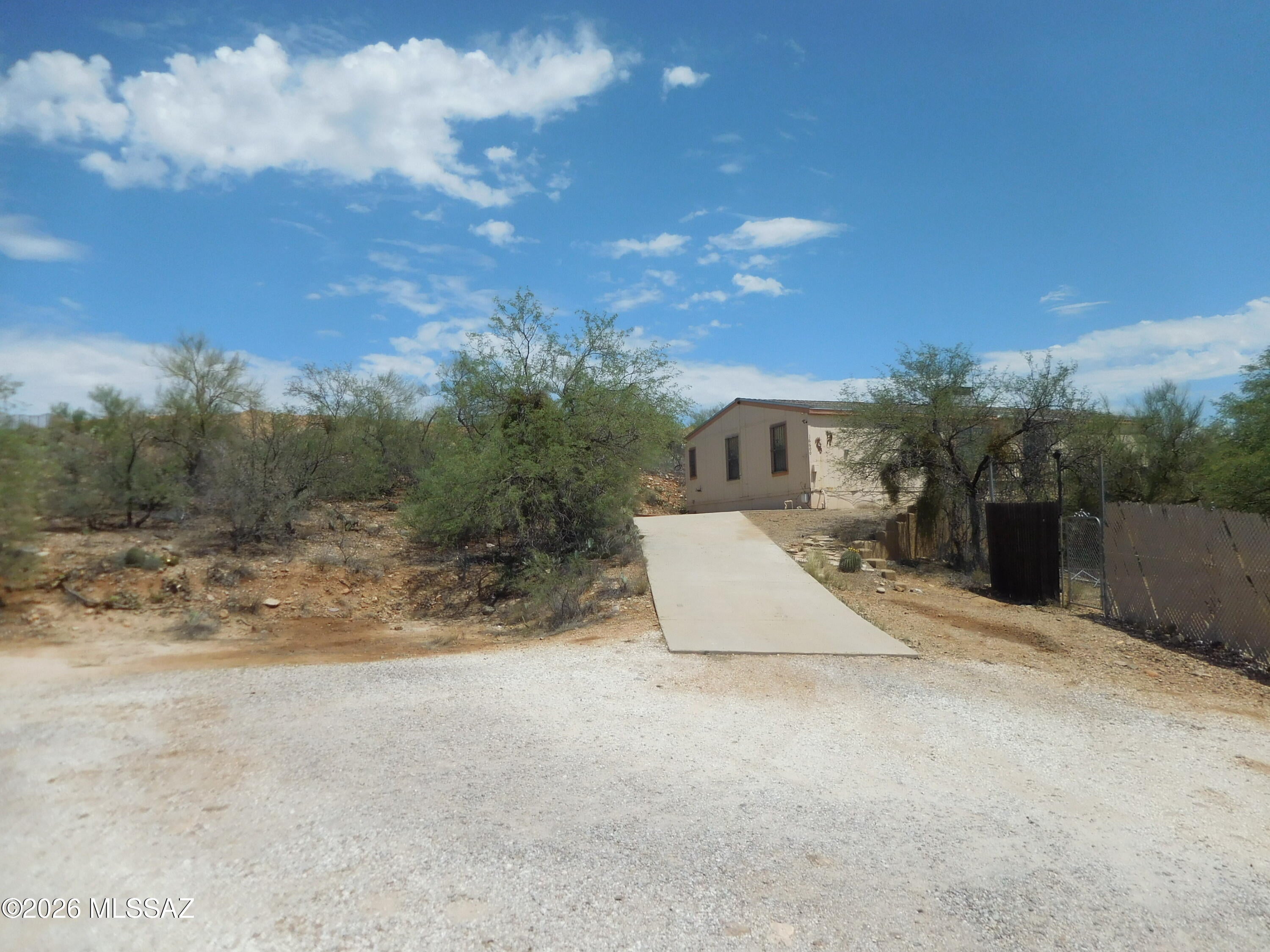 High hillside lot with great views and lots of potential.  This 3Br 2Ba affixed manufactured home does require some TLC repairs.  Rear covered patio, South facing deck with amazing views, separate storage/workshop.