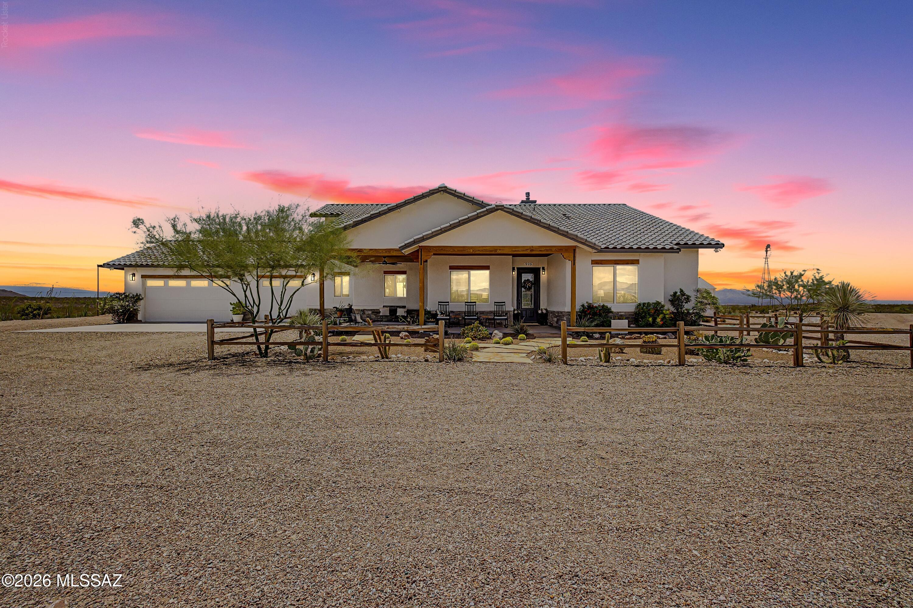 Experience desert luxury at its finest on this premier Tombstone equestrian property! Situated on 20 beautifully maintained, fenced and cross-fenced acres just outside the historic town of Tombstone, this exceptional custom ranchette offers the perfect blend of luxury, functionality, and breathtaking natural beauty. Built in 2022, this thoughtfully designed custom home features just over 2,000 square feet of living space with 3 spacious bedrooms, a versatile den/office, and 2.5 bathrooms. The open-concept floor plan is anchored by a stunning chef's kitchen with an oversized island, ideal for gathering with family and friends, while the inviting gas fireplace creates a warm and welcoming atmosphere. A spacious Arizona room extends your living space outdoors, providing the perfect setting for entertaining or simply taking in the spectacular 360-degree mountain and desert views. Step outside to enjoy the above-ground pool with an expansive deck, where unforgettable Arizona sunsets become part of your daily routine. Every inch of this property has been carefully planned to maximize comfort, convenience, and country living. Equestrian enthusiasts will appreciate the impressive horse facilities, including a 40' X 60' barn with tack room, 3 stalls, 5 horse-runs, and a 150' X 200' roping arena complete with an available roping chute. This property is surrounded by thousands of acres of State and BLM land for endless trail riding! Additional improvements include covered RV parking, a spacious 3-car garage, and a charming she-shed studio featuring its own half bath--ideal for a home office, art studio, guest overflow, or hobby space. Served by a private water company, this remarkable property offers the peace and privacy of rural living without sacrificing modern conveniences. Whether you're looking for a working horse property, a recreational retreat, or your forever home, this one-of-a-kind Tombstone ranchette is ready to exceed your expectations.