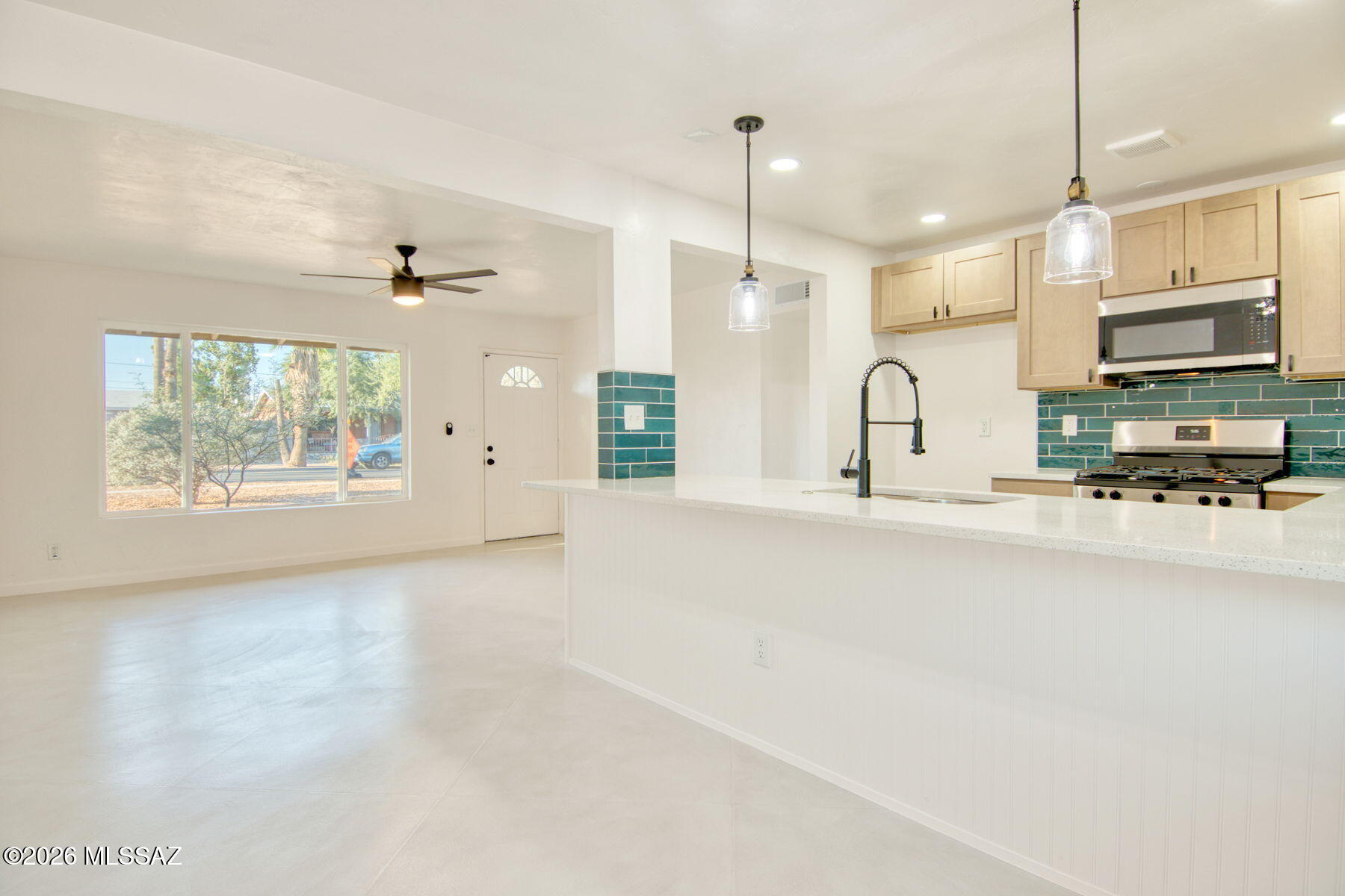 Range priced-Seller will accept or counter offers between $300,000-$320,000. Incredible home! Spectacular burnt adobe block home in central Tucson, artfully remodeled with beautiful curb appeal. Open the door and walk into this amazing updated home. 1957 Mid-century meets 2027 comfortable modern. Open kitchen with large island, custom concrete floors, quartz counter tops and a huge .20 acre lot. 4 cozy comfortable bedrooms and 2 luxurious spa-like bathrooms.  Mature trees and north/south exposure with mountain views from the backyard. Incredible location close to U of A, downtown, Davis Monthan and Raytheon. new dual pane energy efficient windows, New HVAC and attention to detail is evident throughout.  New shingles, fresh paint inside and out and gorgeous! Owner/Agent