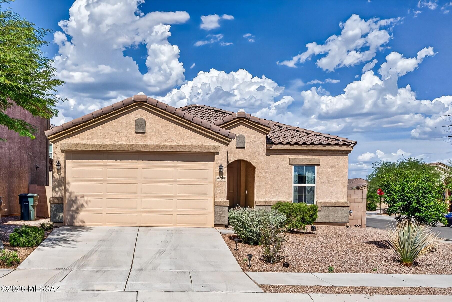 Feel right at home in this charming 2021-built 3-bed, 2-bath residence on a desirable corner lot with owned solar, a soft water system, and a tankless water heater. The bright open-concept great room with wood-look tile flooring flows seamlessly into the dining area and kitchen, featuring a large island with breakfast bar, granite counters, stainless appliances, gas range, reverse osmosis, walk-in pantry, and extended-height cabinetry with crown molding. The owner's suite offers new carpet and pad, dual vanity, walk-in shower, and a sizable walk-in closet. Two more bedrooms with new carpet, hall bath, laundry room with washer/dryer included, ceiling fans throughout, covered patio, and low-maintenance backyard complete this energy-efficient Tucson gem.