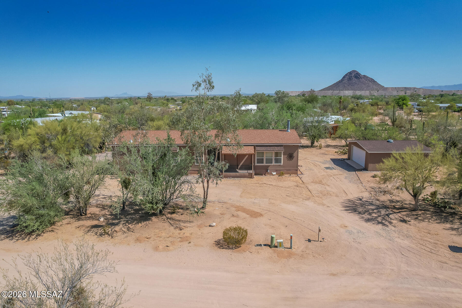 Space. Privacy. Room to Roam! 
Enjoy the freedom of country living on a full acre with stunning desert & mountain views and plenty of room for your toys, hobbies and outdoor lifestyle. This spacious 3-bedroom, Den, 3-bath home offers 2,160 SF with a comfortable floor plan and the privacy you've been looking for. Living room with corner fireplace, family room off kitchen w/island, breakfast bar, pantry, laundry room off kitchen. The property also features an unattached garage, 2-car carport and additional storage--perfect for vehicles, equipment and all the extras that come with country living. Escape the hustle and enjoy wide-open space, beautiful Arizona skies and the freedom to make this property your own!