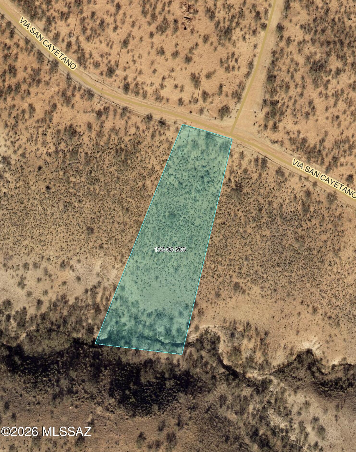 Flat 1.64-acre homesite on Via San Cayetano in Rio Rico Ranchettes, with power lines along the street and no HOA. At well over an acre, there is room for a custom home, garage, shop and yard, with space between you and the neighbors. Zoned SCC R-2 for a single-family build. Via San Cayetano connects to Avenida Pastor and Pendleton Dr, about 12 minutes to I-19 at Palo Parado for an easy drive to Tubac, Nogales and Tucson. Water service is not at the lot today, so the price reflects it. Buyer to verify water availability, electric service, septic/perc and building requirements with the providers and Santa Cruz County.
