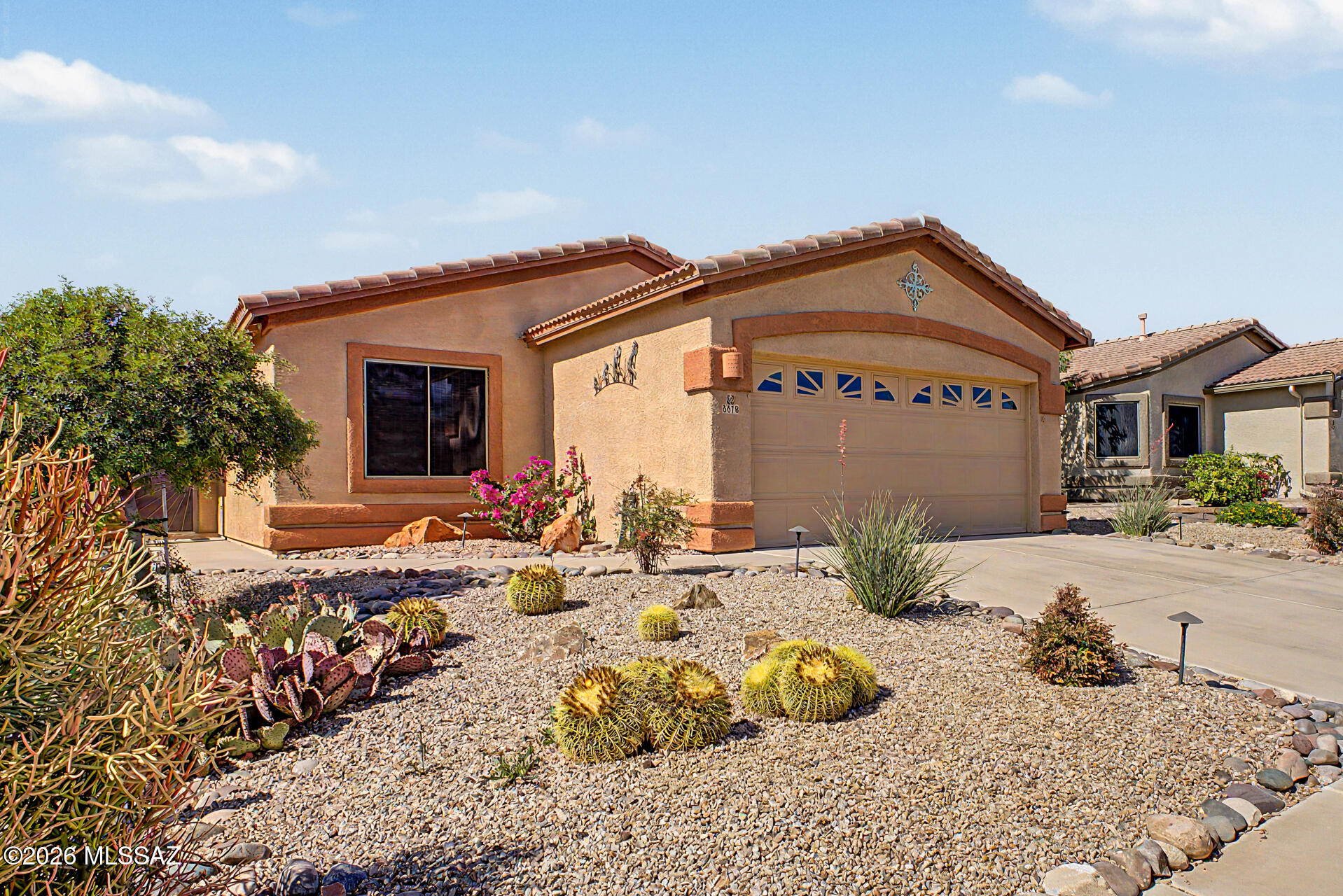3 bedroom, 2 full bath home sits on a quiet cul-de-sac in the Villages at Dove Mountain. The sundrenched split floor plan boasts no carpet throughout, a corner gas fireplace in the living room, and a spacious kitchen with many cabinets, a pantry, dining area, granite countertops, and a brand new refrigerator. Additional upgrades include a newer HVAC, water softener, and irrigation system. Step outside to your large, private fenced backyard, perfect for entertaining or enjoying beautiful Arizona evenings, and a garage offering extra storage to keep everything organized. The location couldn't be better -- just a stone's throw from Dove Mountain Community Park, featuring basketball, tennis, sand volleyball, BBQ grills, a playground, dog parks, and scenic walking trails right at your doorstep!