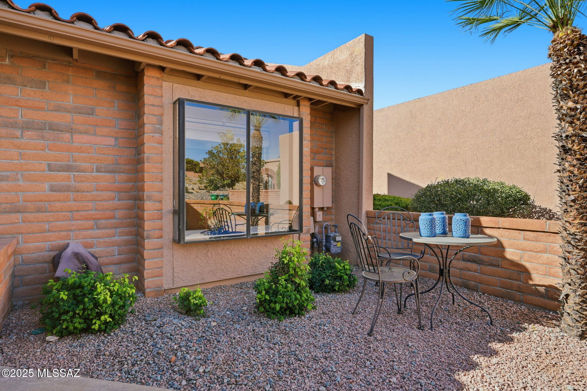 Soak in the beauty of the Santa Rita Mountains from your spacious back paver patio, an inviting outdoor retreat perfect for sunrise coffee, evening sunsets, and year-round desert living. Inside, the bright kitchen captures the charm of AZ with skylights, a garden window, and SS appliances. The open LR/DR features a newer south-facing slider wall of windows, also enjoyed in the primary bedroom, filling the home with sunshine and framing those classic desert skies. Your guests will love their own versatile space, complete with a wall bed, built-in desk, generous storage, and a window overlooking the private front courtyard. An oversized 2-car garage with abundant storage cabinets ensures room for all your gear, and desert essentials. This TH is ready to be your ''Home Sweet Desert Home''.