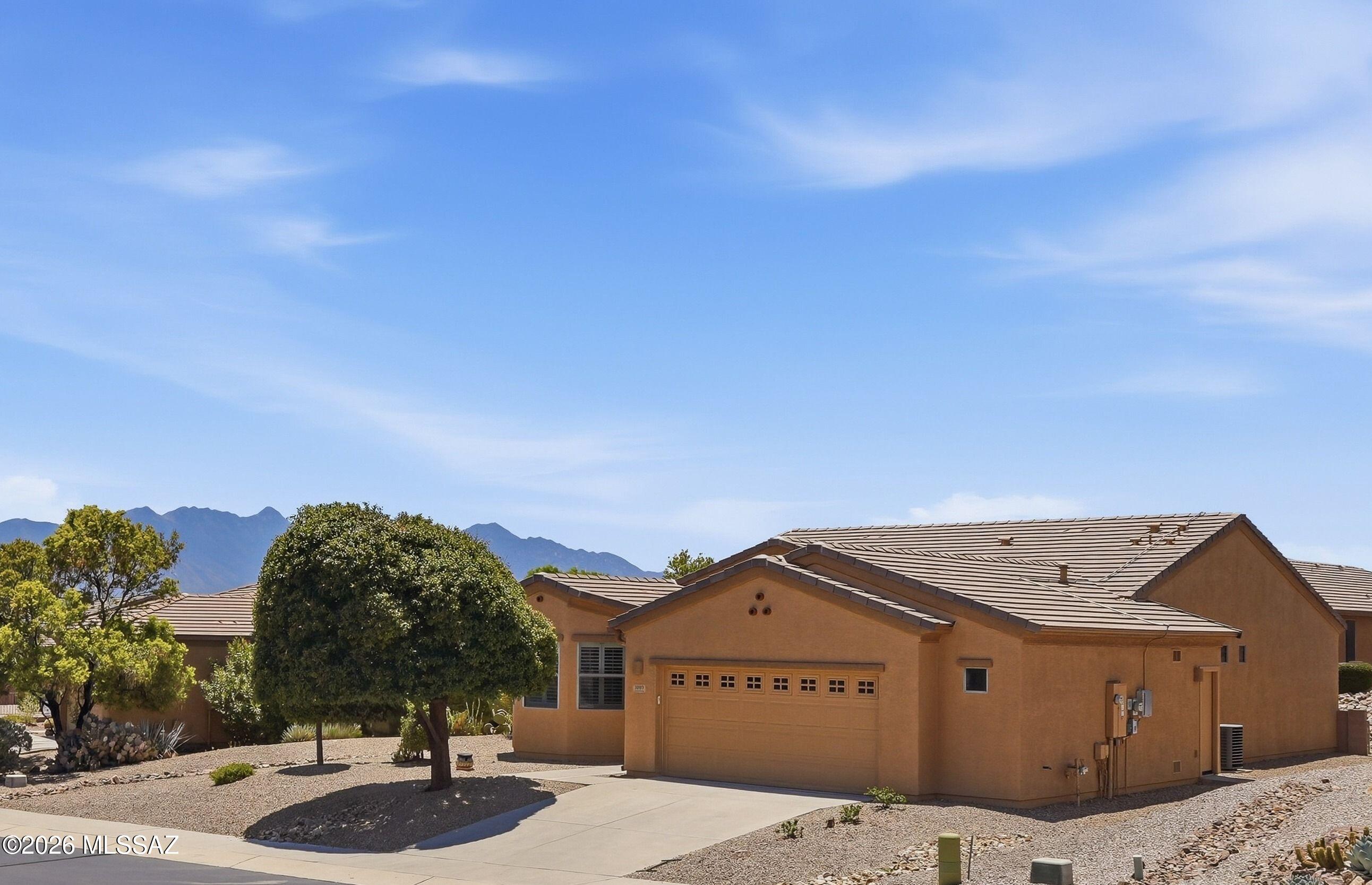 With a new roof & exterior paint in 2025 + owned solar for lower cost electric, this 2-bedroom, 2 bath + Den 1,584 sq ft home built in 2009 is well maintained so you can go out & enjoy all that Green Valley has to offer inc. golf, GVR facilities, Restaurants, Shopping & Farmers Markets! Return home to relax in a Screened Porch/AZ room or low care landscaped backyard. Security front & back doors allow air flow through the open concept living, dining & kitchen w/breakfast bar, pantry, ample quartz countertops & cabinets w/pull outs & gas range/oven. Split Bedroom Floor plan. Primary bedroom w/walk-in closet & en-suite bath w/walk-in shower. Diagonal tile flooring other than carpet in Bedrooms & Den. Water Softener. Lg. Laundry Rm. 2 ½-Car attached garage has storage & space for a golf cart!