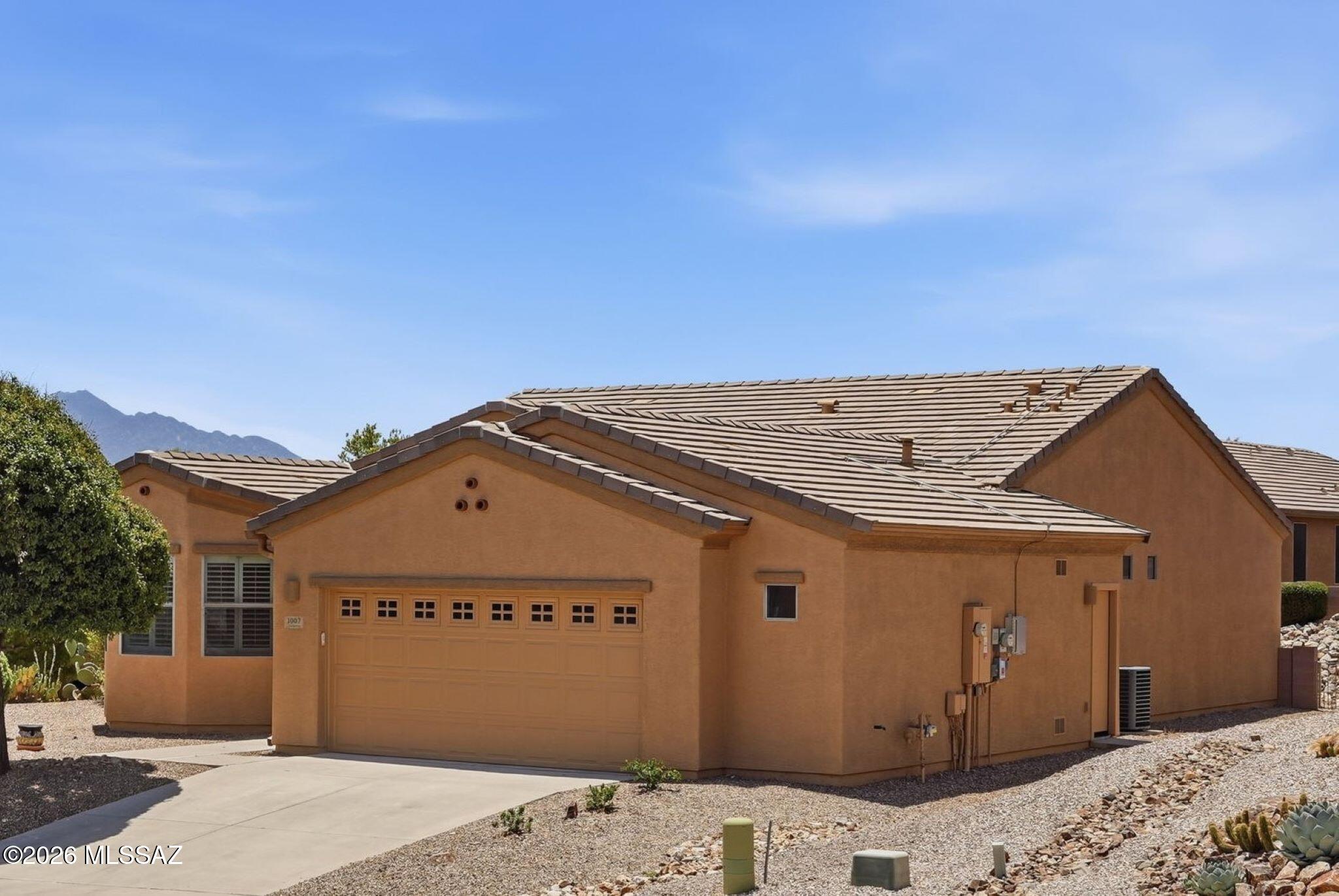 With a new roof & exterior paint in 2025 + owned solar for lower cost electric, this 2-bedroom, 2 bath + Den 1,584 sq ft home built in 2009 is well maintained so you can go out & enjoy all that Green Valley has to offer inc. golf, GVR facilities, Restaurants, Shopping & Farmers Markets! Return home to relax in a Screened Porch/AZ room or low care landscaped backyard. Security front & back doors allow air flow through the open concept living, dining & kitchen w/breakfast bar, pantry, ample quartz countertops & cabinets w/pull outs & gas range/oven. Split Bedroom Floor plan. Primary bedroom w/walk-in closet & en-suite bath w/walk-in shower. Diagonal tile flooring other than carpet in Bedrooms & Den. Water Softener. Lg. Laundry Rm. 2 ½-Car attached garage has storage & space for a golf cart!