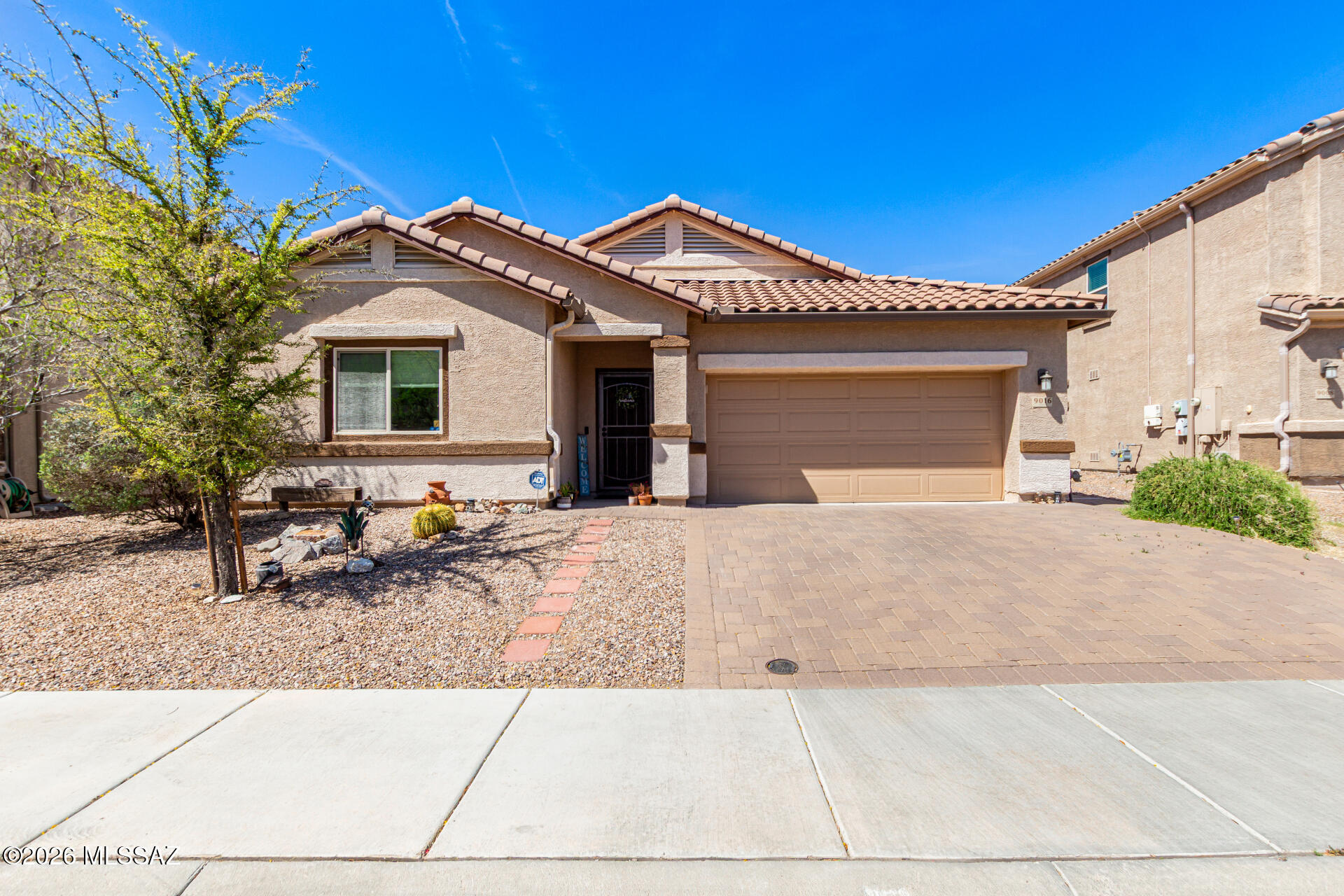 Seller to consider offers between $399,500 - $415,000 range price. Welcome to this beautifully appointed 3 bedroom, 2.5 bath home w/ den in the sought after Saguaro Bloom community in Marana. Designed with a split bedroom floor plan for added privacy, this home features granite countertops in kitchen, stainless steel appliances, and a spacious kitchen island ideal for culinary enthusiasts, gathering, and everyday living. Soft, neutral earth-tone paint creates a warm, calming atmosphere throughout. The open concept great room flows effortlessly to the backyard, perfect for entertaining. Step outside to a thoughtfully designed yard with pavers, mature cacti, a lemon-orange hybrid tree and lush landscaping. An inviting retreat to enjoy your morning coffee or unwind with an evening cocktail under Arizona's stunning skies and breathtaking sunsets. A perfect blend of comfort, style, and easy living. Enjoy Saguaro Bloom's resort style amenities including a refreshing pool and splash pad, fully equipped fitness center, welcoming recreation center, and fun community events like local food trucks.