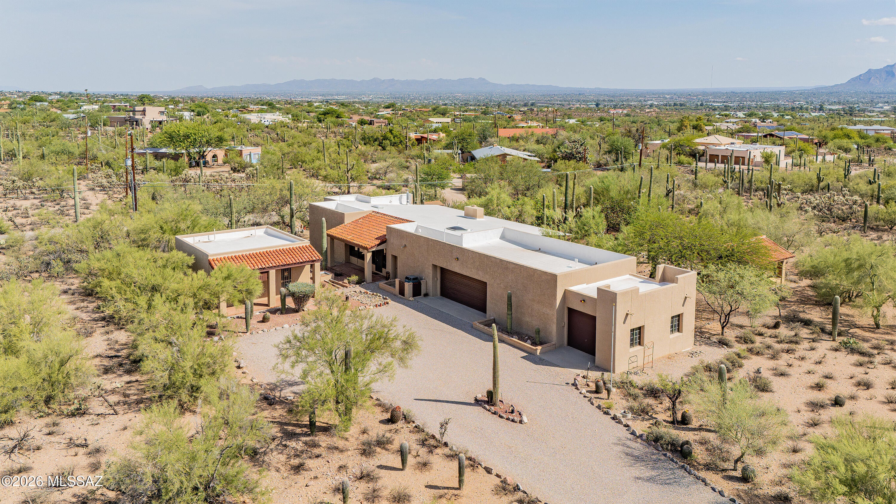 Set among mature saguaros, citrus trees, and wide-open desert surroundings, this distinctive custom-built property offers a rare combination of space, privacy, versatility, and authentic Tucson character. Thoughtfully designed and lovingly maintained by its original and only owner, the home sits on an expansive lot where natural desert beauty and mountain and city views create a peaceful sense of retreat.
Inside, generously sized bedrooms provide exceptional comfort, while a dedicated office with built-in bookshelves creates an ideal setting for working from home, reading, or pursuing personal interests. The thoughtful floor plan offers abundant space to gather, relax, and enjoy everyday living while maintaining a wonderful connection to the surrounding landscape.
A separate casita adds tremendous flexibility for today's lifestyle, giving family members or guests the comfort and privacy of their own space with a full kitchen, living area, and bath. It is equally well suited as a private home office, creative studio, or extended-stay retreat while remaining conveniently connected to the main residence.
One of the property's most impressive features is the huge detached workshop, complete with water and electricity. With exceptional room for automotive projects, woodworking, hobbies, equipment, storage, or a creative workspace, it is a valuable amenity rarely found in a residential setting. For those seeking even greater privacy, additional space, or future possibilities, an adjacent lot is also available for separate purchase--creating a unique opportunity to expand the property or preserve additional open space around the home.

All of this is conveniently located just minutes from hiking and outdoor recreation, Starr Pass, Downtown Tucson, the University of Arizona, and everyday amenities. A truly special property offering room to live, work, create, entertain, and enjoy the desert landscape on your own terms.