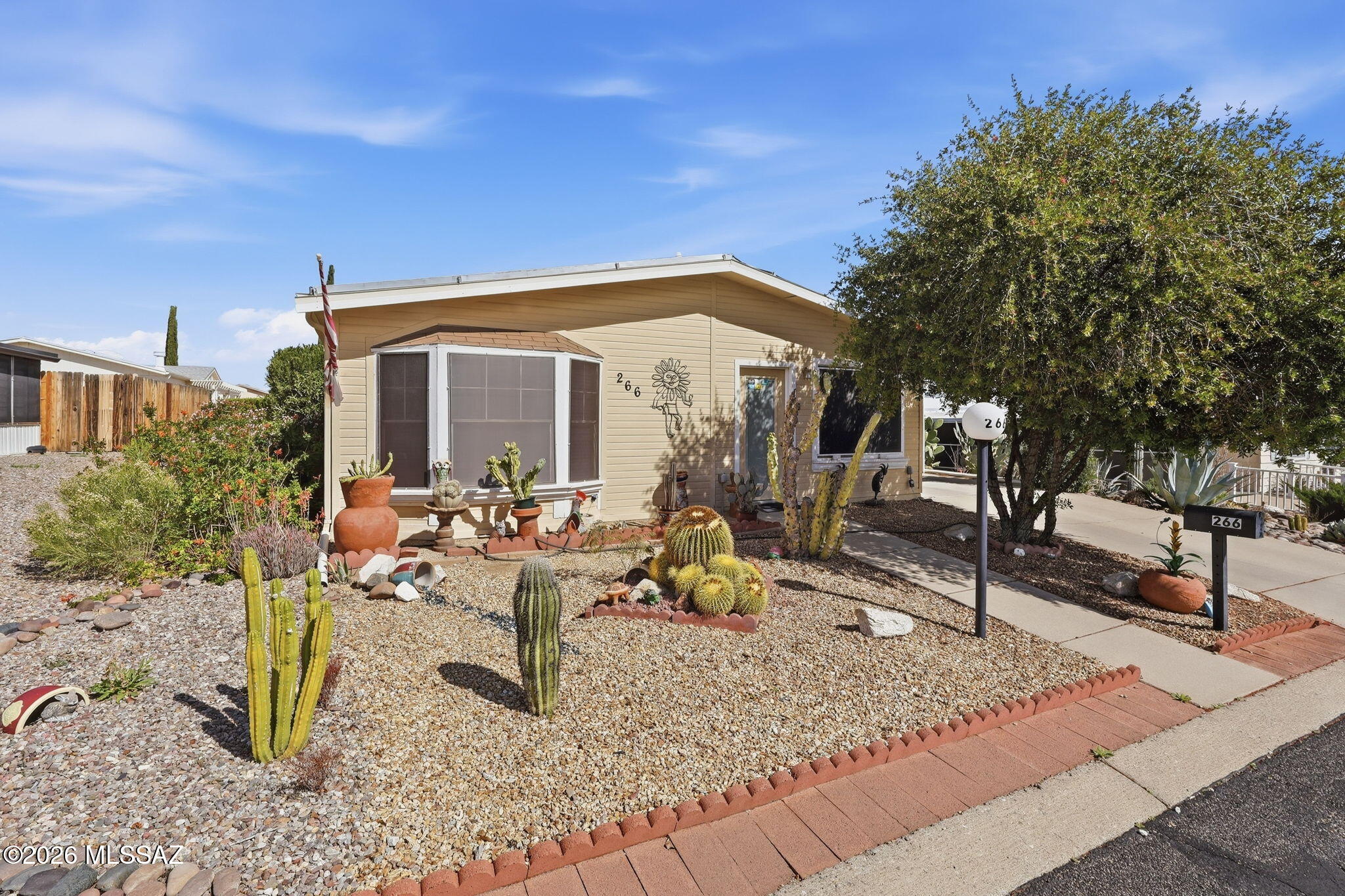 VIEWS AND OWNERSHIP IN THIS CHARMING  2 BEDROOM, 2 BATH FURNISHED HOME WHERE YOU OWN THE LOT IN DESIRABLE PUEBLO ESTATES 55+ COMMUNITY.
SOAK IN THE MOUNTAIN VIEWS, SUNSETS AND SUNRISES FROM THE SOUTHEAST FACING ARIZONA ROOM. YOU HAVE A PRIVATE BACK PATIO PERFECT FOR GRILLING AND QUIET RELAXATION. WORKSHOP FOR SMALL PROJECTS OR STORAGE, ENJOY YEAR-ROUND COMFORT WITH AN EFFICENT ELECTRIC HEAT PUMP FOR HEATING AND COOLING. ROOF COATED  5/24. UNDER TERMITE WARRANRY. HOA $65.00 MO. INCLUDE HEATED POOL AND HOT TUB. RECREATIONAL CENTER TO EXPLORE THE ACTIVITIES. EXERCISE ROOM, BILLIARDS, LIBRARY, AND CERAMIC ROOMS, TRASH PICK-UP, COMMON AREA AND STREET MAINTENANCE. GREAT LOCATION, CLOSE TO SHOPPING, RESTAURANTS, PLACE OF WORSHIP, DOCTOR OFFICES, HOSPITAL AND GOLF.  NO GVR, BUT IT IS AVAILABL