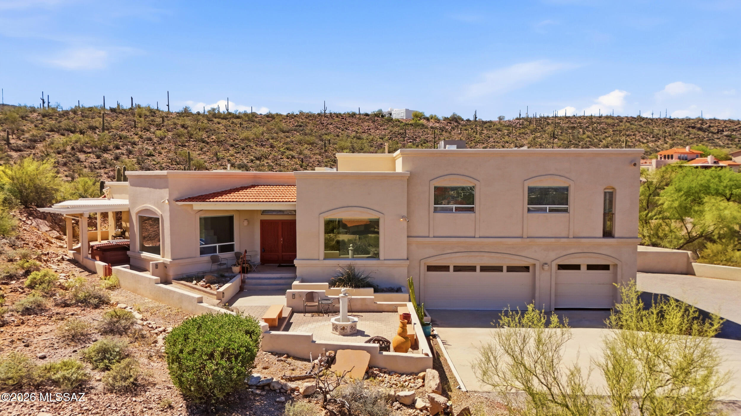 First time ever on the market, this home offers privacy, and breathtaking views in a highly desirable Tucson location. Built in 2001, this 3401sq ft. main home features 4 bed/3.5 bath, plus an attached 1 bed/1 bath guest home addition, roughly 550sq ft with separate entrances. Perched at the top of a hill, the property captures views of the surrounding desert, city and mountains. Inside, you'll find vaulted ceilings, split-bedroom and a combination of tile and carpet flooring. This home presents an incredible opportunity for buyers looking to personalize and add value. Priced as the lowest price per square foot in the neighborhood, it provides immediate upside potential for customization and equity growth. Don't miss a chance to own a one-of-a-kind hilltop home with endless possibilities.
