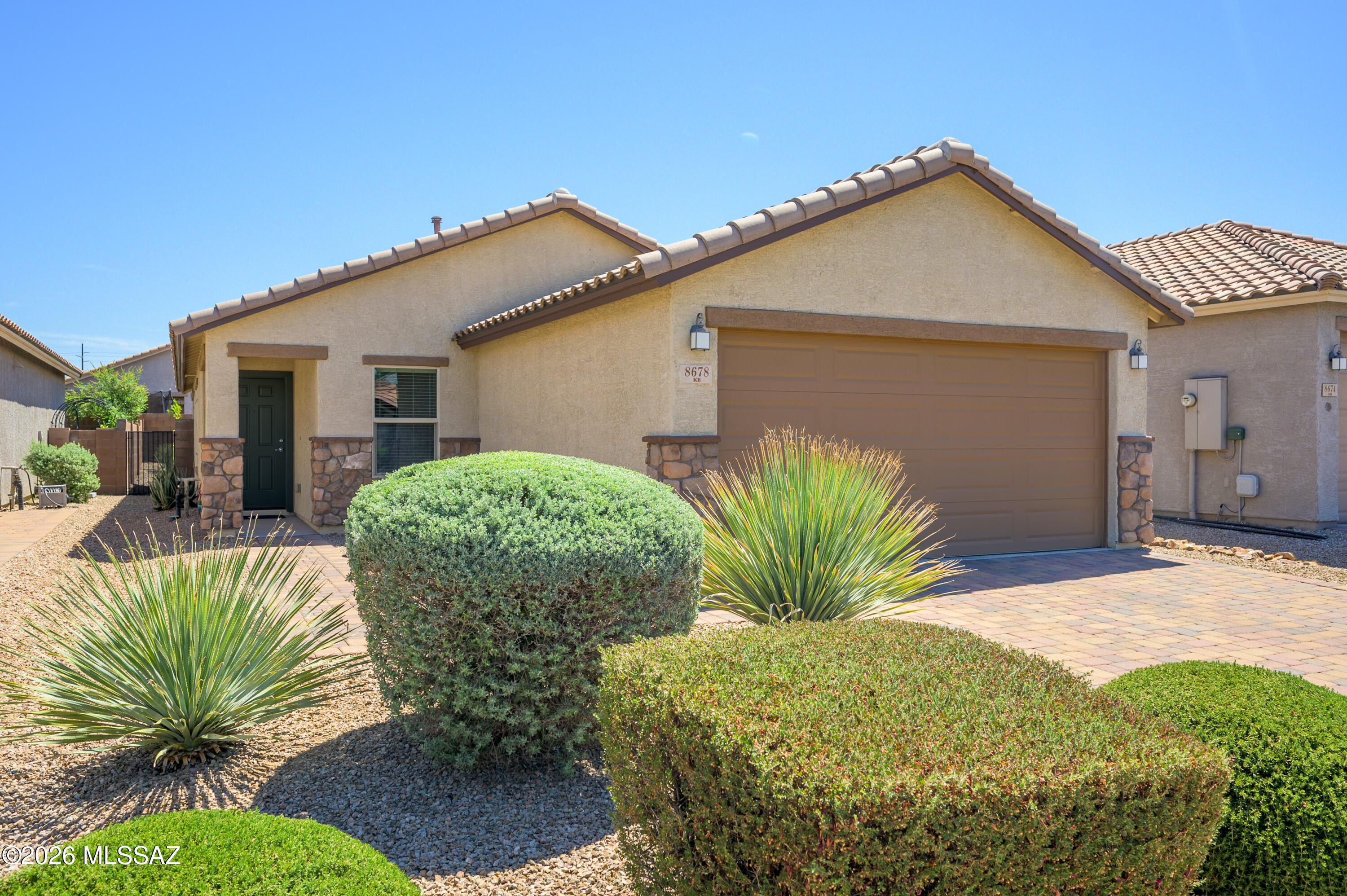 Live minutes from premier shopping, dining, healthcare, and recreation along the Oracle Road corridor. Located within a gated community of just 94 single-story residences, this beautifully maintained 3-bedroom, 2-bath home offers the perfect blend of comfort, convenience, and low-maintenance living.
Built in 2018, the thoughtfully designed split-bedroom floor plan is filled with natural light and features 1,465 square feet of inviting living space. The kitchen is appointed with warm wood cabinetry, pull-out shelves, quartz countertops, a glass tile backsplash, and a center island with sink. The spacious primary suite includes new carpet and a bath with dual vanities. Solar screens help improve comfort and energy efficiency throughout the home. Click more. Enjoy Arizona living outdoors with a covered patio featuring an electric roll-down screen for added privacy and shade, a coated patio surface, and a low-maintenance backyard complete with a putting green. Additional highlights include a stone veneer exterior elevation, paver driveway, and paver walkway.
Ideally located near shopping, dining, healthcare, and recreation, with convenient access to Northwest Medical Center, Casas Adobes Plaza, Uptown/Foothills Mall, Oracle & Magee shopping, and I-10. Situated within the Amphitheater School District, this move-in-ready home offers an exceptional Northwest Tucson lifestyle.
