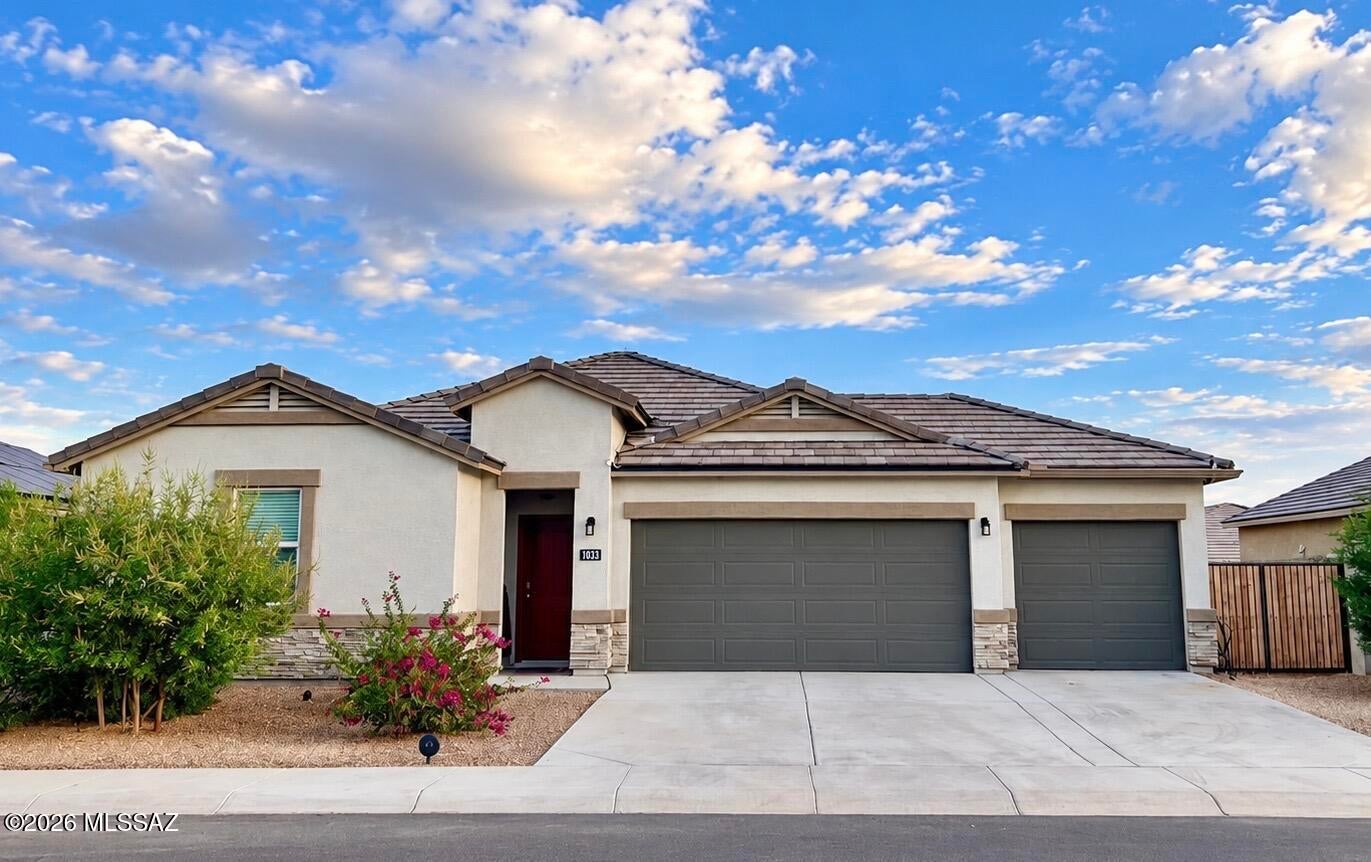 Built in 2022, this 4 bed, 2 bath home features a split floor plan with a spacious kitchen offering a large corner pantry, granite countertops, stainless steel appliances, and Espresso cabinets. The kitchen overlooks the great room, perfect for entertaining. Secondary bedrooms include walk-in closets. Interior finishes include 20'' tile in main areas, cultured marble bath vanities, and window blinds. Enjoy a 3-car garage, smart home package, garage door opener, and desert landscaping front and back.