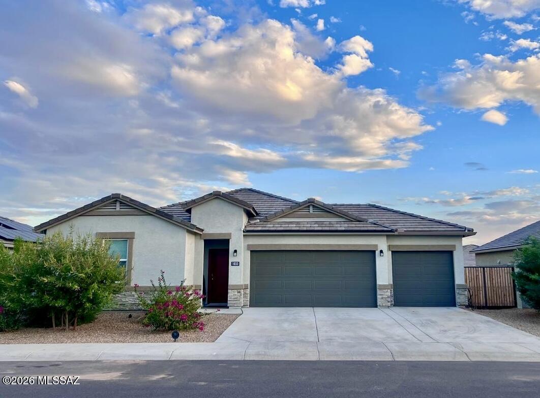 Built in 2022, this 4 bed, 2 bath home features a split floor plan with a spacious kitchen offering a large corner pantry, granite countertops, stainless steel appliances, and Espresso cabinets. The kitchen overlooks the great room, perfect for entertaining. Secondary bedrooms include walk-in closets. Interior finishes include 20'' tile in main areas, cultured marble bath vanities, and window blinds. Enjoy a 3-car garage, smart home package, garage door opener, and desert landscaping front and back.