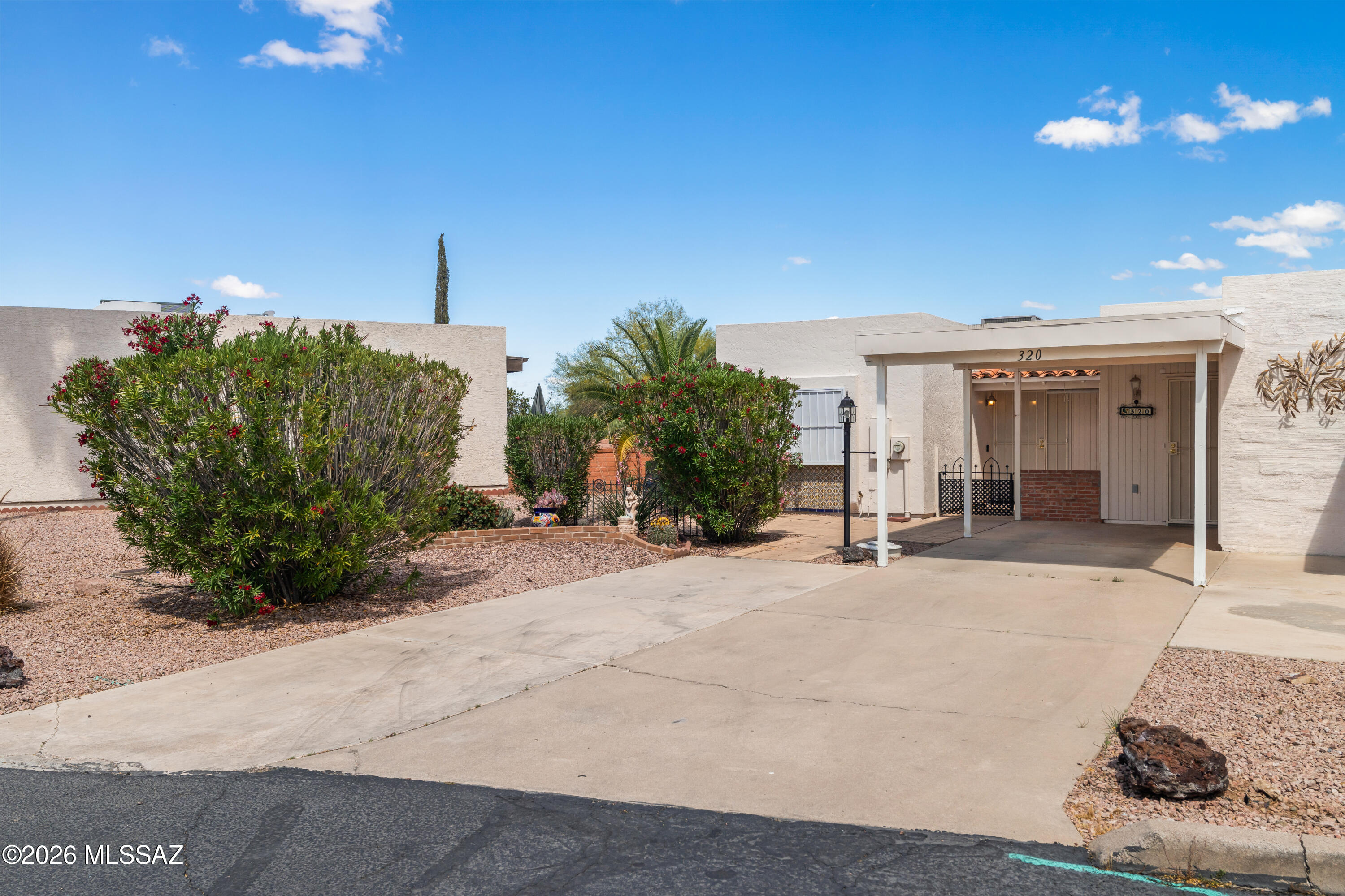 Whether you're seeking a full-time residence or the perfect seasonal retreat, this 2-bedroom, 2-bathroom townhome is sure to impress. The heart of the home features a nice kitchen complete with butcher block countertops and sleek appliances. You'll find easy-care tile and laminate flooring throughout, complemented by a fresh interior paint. The versatile Arizona room offers extra living space for relaxing or a hobby area, while two dedicated storage units provide plenty of room for gardening tools and gear. While the front carport is advertised for a single car, the concrete pad can accommodate up to three vehicles--perfect for your car, guest parking, and a golf cart! Privacy is a priority here: the guest wing functions as a true private suite. Come see all Green Valley has to offer!