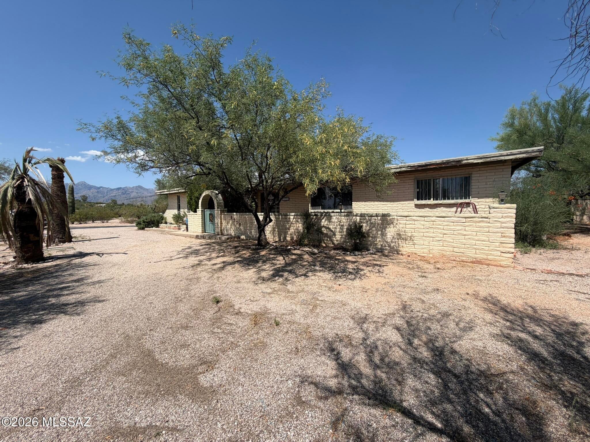 A rare opportunity in the desirable Tanque Verde Valley! Situated on 1.59 acres, this spacious 2,576-square-foot home features a split floor plan & offers outstanding potential for renovation and personalization. The expansive lot is a major highlight and  includes a detached garage/workshop, RV parking with a 120V hookup, and plenty of room for a guest house, ADU, recreational vehicle storage, pickleball/basketball/tennis court, stargazing deck, or custom outdoor living space. Ideal for buyers with a vision seeking privacy, flexibility, tranquil surroundings, stunning mountain views, and room to create a property tailored to their lifestyle. Priced to reflect its current condition and offered as-is. Bring your contractor and design ideas to maximize the potential of this spacious estate!