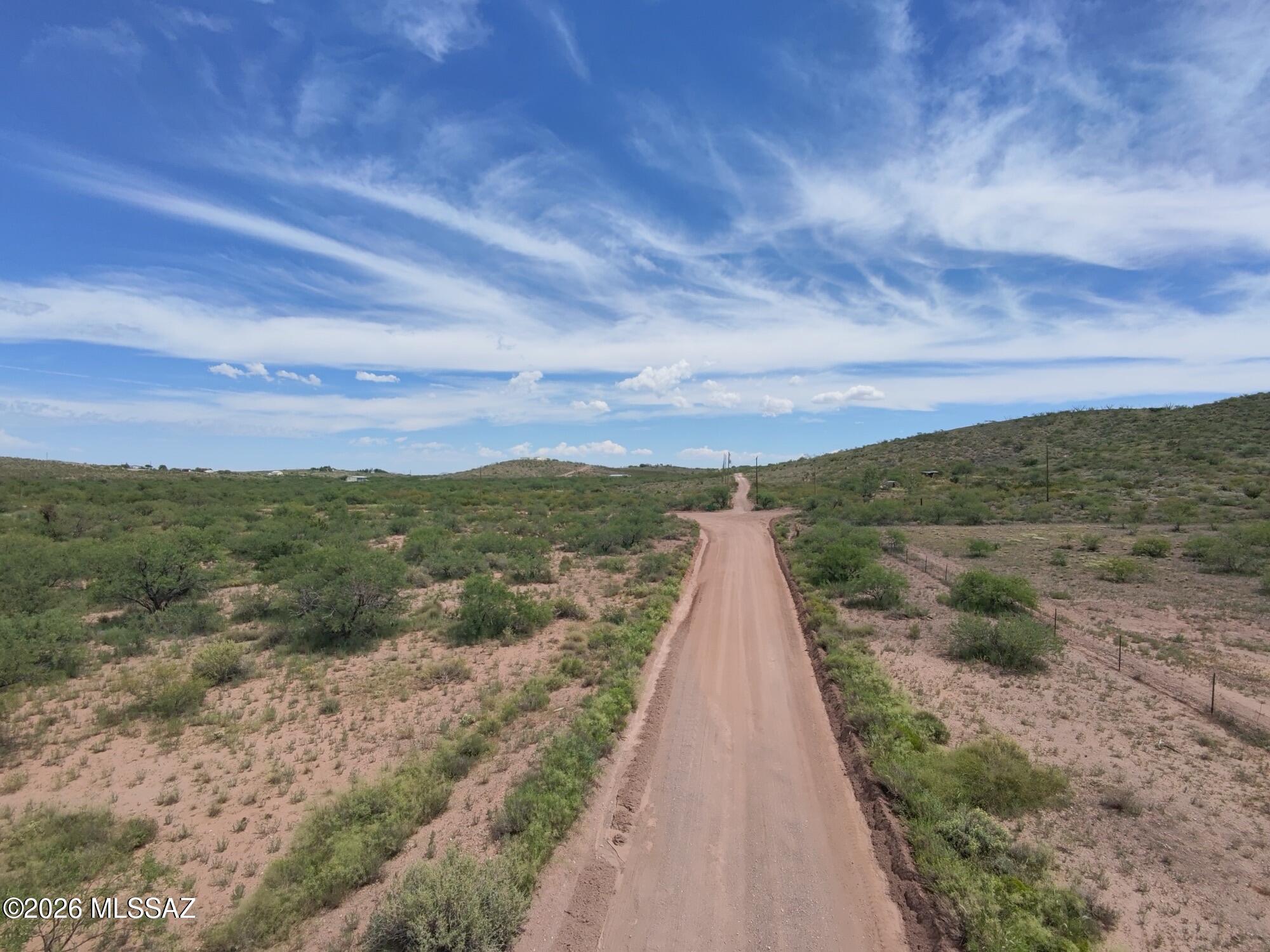 10.05 Acres | Pima County RH Zoning | Road Frontage | No HOA | Rolling Terrain | Rural-Residential Setting
This just over 10-acre parcel features approximately 331 feet of road frontage and extends more than 1,300 feet, providing plenty of space for a future homesite, recreational use or rural retreat. Zoned RH with no HOA, the property is situated among developed acreage properties while still offering the space and privacy that comes with owning 10 acres.
Enjoy the natural desert landscape, wide-open skies and mountain surroundings while remaining within driving distance of Benson, Vail and the greater Tucson area. Buyers should independently verify utilities, water, septic, access, flood-zone status, zoning requirements and suitability for their intended use.