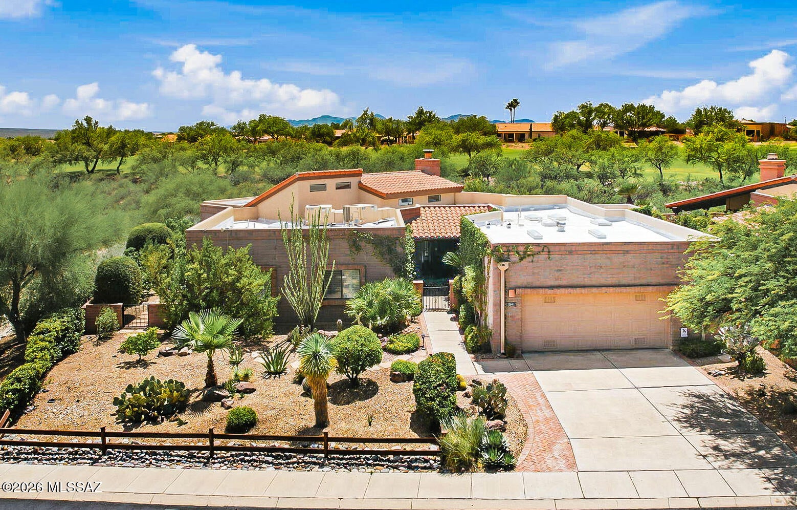 If privacy, views, and room to spread out are on your wish list, this one is not to be missed! Enjoy breathtaking mountain views from the expansive patios, surrounded by fruit trees that give this property a true oasis-in-the-desert feel. The interior offers a spacious living room with huge windows, gas fireplace, & custom carved-wood wet bar. The large kitchen features abundant storage, a chef stove, wine fridge, and convenient drawer roll-outs. A separate circular dining room is ideal for entertaining. Retreat to the primary suite with vaulted ceilings, spacious bath, & semi-private flex addition. A second bedroom, bath, office/den, and two more flex rooms offer endless options for hobbies, creativity, or work. Close to GVR centers, with pools, gyms and classes. Privacy and views await!