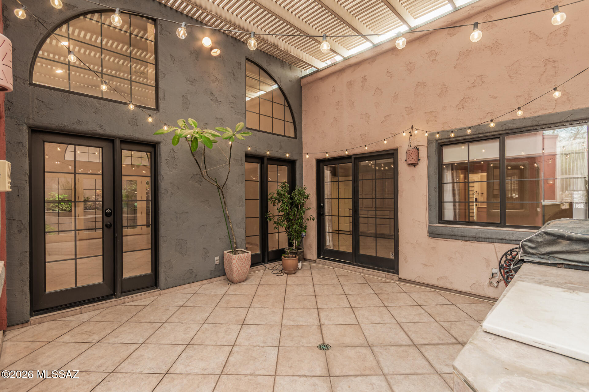 Located in the coveted Sam Hughes neighborhood, this 5-bedroom townhome is one of the largest in the area and sits on a rare double lot offering space, privacy, and flexibility rarely found in Sam Hughes. Enjoy exceptional walkability to local bars, restaurants, the University of Arizona, and Himmel Park, plus a sparkling community pool and spa just a short walk away. A large front bedroom with private entrance is ideal for rental income, guests, or flexible living. The kitchen is fully upgraded with a Bosch Benchmark induction cooktop, KitchenAid convection oven, microwave, and dishwasher, Zephyr hood, and Samsung smart refrigerator. All 3 bathrooms have been renovated with rebuilt showers, new counters, fixtures, and toilets. Additional upgrades include dual Lennox HVAC systems with smart thermostats, LG Signature washer and dryer, smart garage opener, Nest safety system, water heater, and disposal move-in ready in one of Tucson's most desirable locations. Sparkling Heated Pool and spa for year round enjoyment, all included in HOA. HOA fee covers front yard maintenance (irrigation, cutting grass, tree maintenance, etc.), the heated pool and spa, and road maintenance for Joesler Ct.