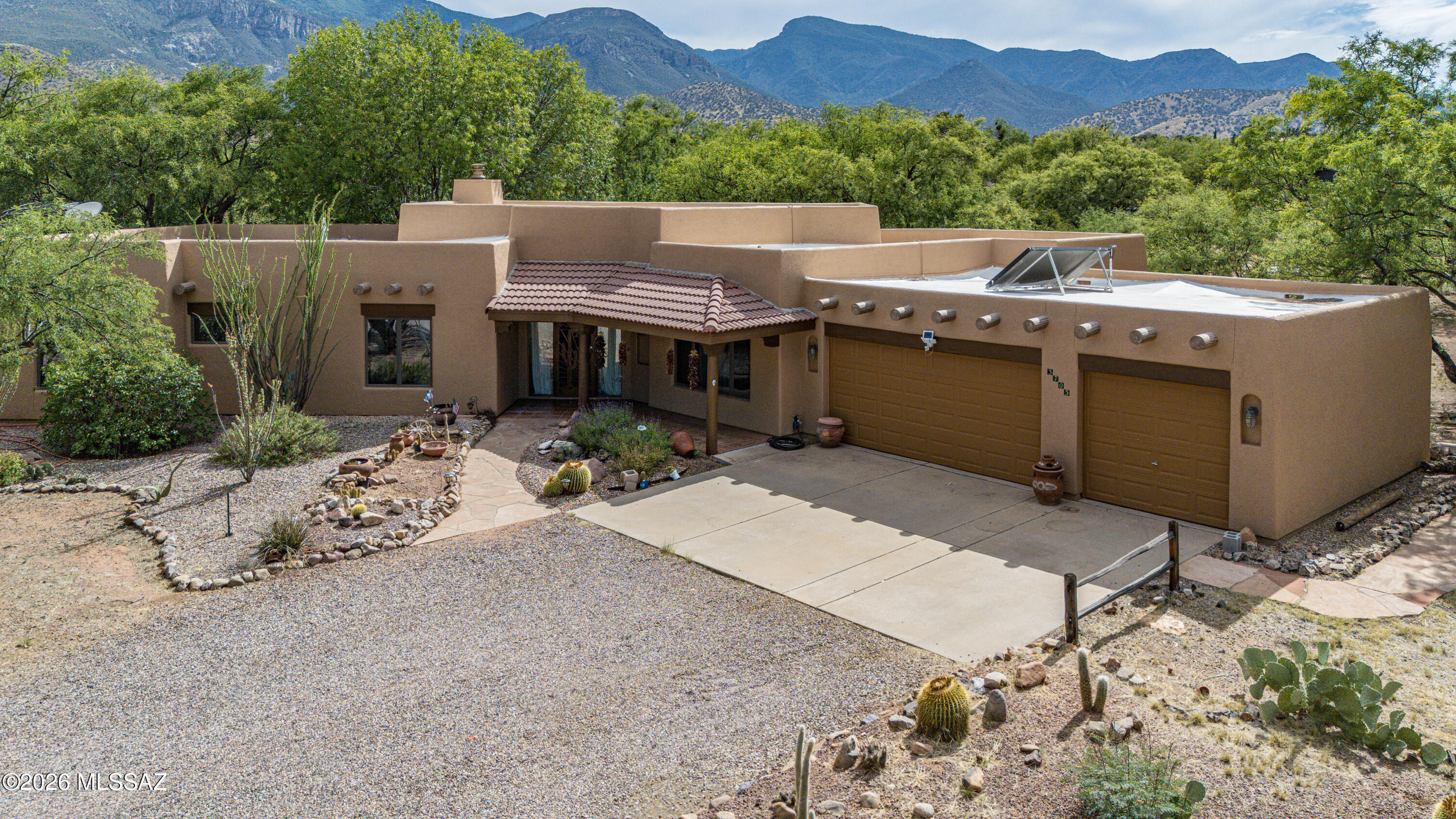 Set on 1.6 private acres, this beautifully maintained 4-bedroom, 3 bath home offers space, character, and comfort. The thoughtfully remodeled kitchen blends modern convenience with timeless style, while fresh interior and exterior paint create a bright, move-in-ready feel throughout.Warm Saltillo tile floors, exposed wood beams, and a cozy beehive fireplace add distinctive Southwestern charm. Anderson windows fill the home with natural light and showcase views of the lush surroundings. A formal dining room provides the perfect setting for entertaining and can easily serve as a second living area.