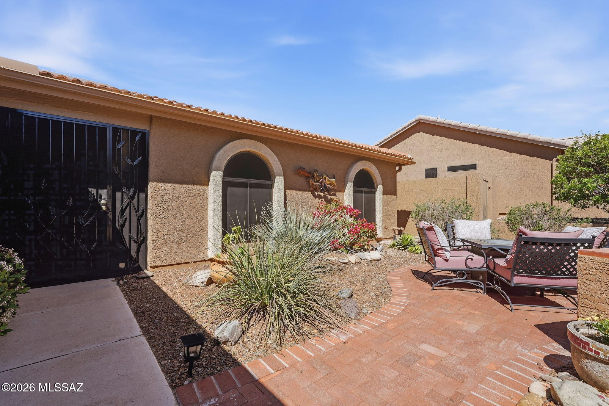 Welcome to this beautifully maintained 3 BD/2BA Alameda model in the highly desirable active-adult community of SaddleBrooke. This inviting home features a bright, open floor plan perfect for everyday living and entertaining. The updated kitchen showcases elegant quartz countertops, complemented by a convenient quartz wet bar ideal for hosting guests. Both bathrooms have been tastefully updated, and the cozy gas fireplace adds warmth and charm to the living space. Additional highlights include ceiling fans in all bedrooms, recirculating water pump, fresh exterior paint (2024), hot tub hookup, and updated irrigation system. Step outside to enjoy the private backyard featuring two citrus trees and a dedicated garden area, creating the perfect setting for relaxing.  Solar screens help with lower electric bills.