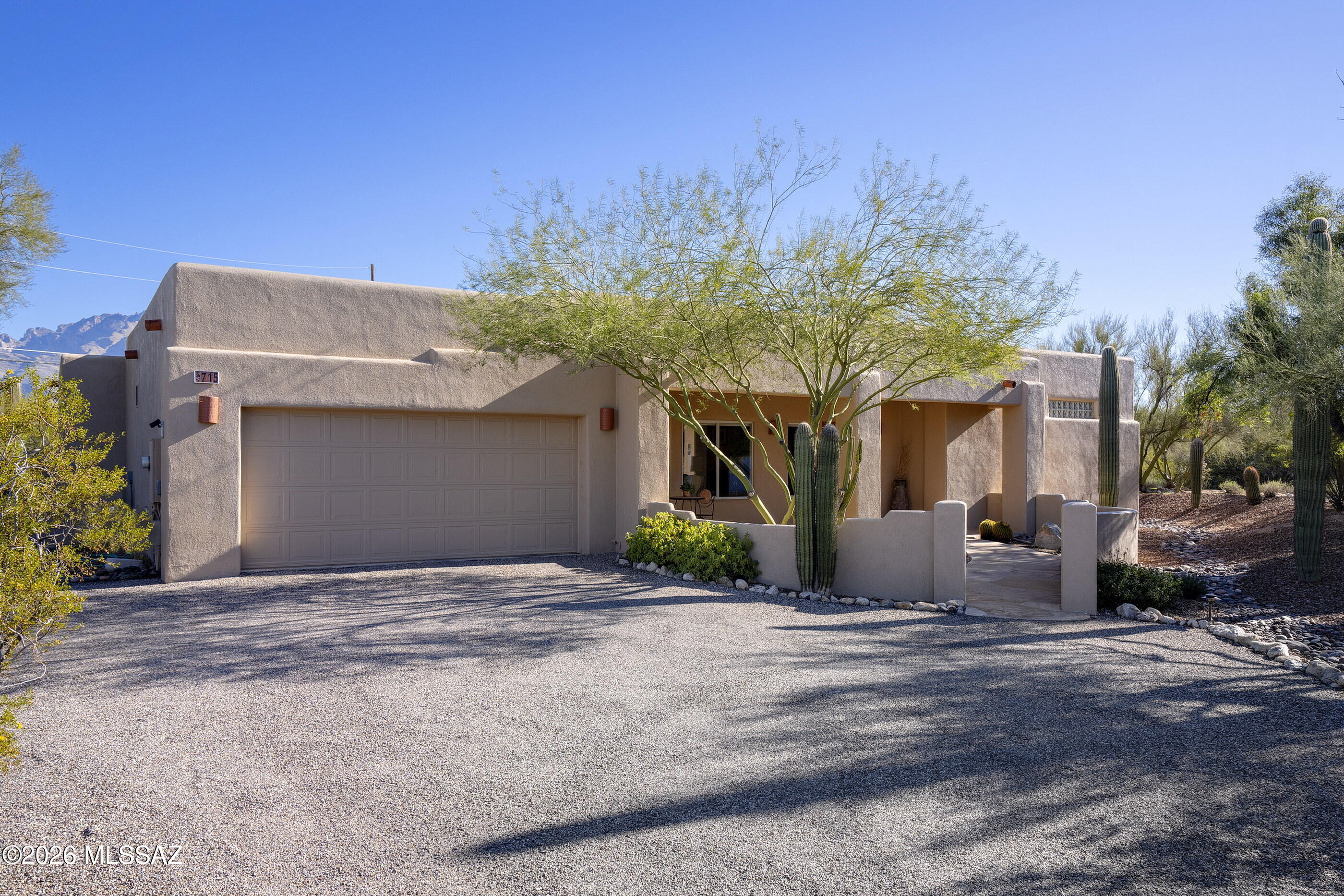 Spectacular mountain views as you enter this beautiful 4BR/2BA split bedroom plan home on a saguaro studded .9 acre lot with No HOA...Natural light is one to the highlights of this pristine home, high ceilings and walls of windows bring in the stunning desert landscape. Open, sit at island kitchen features granite countertops, custom tile backsplash and newer upscale appliances. Beautiful living room with large dining area is the heart of the home with a gas burning fire place. All open to the beautiful flagstone patio with the gorgeous panoramic mountain view. Primary suite is spacious and features a walk in closet, separate tub and shower and and dual vanity. On the other side of the home are 3 bedrooms with and an updated hall guest bath.  Serene secluded area of upscale homes.