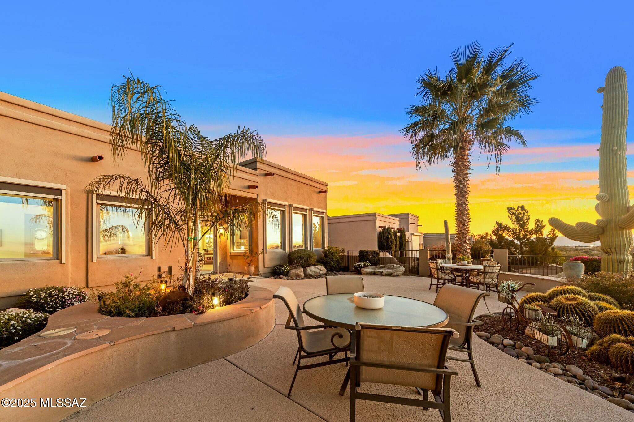 Nestled in a peaceful cul-de-sac within an upscale enclave, this exceptional home offers a perfect blend of luxury, comfort, and breathtaking sunsets. Overlooking the eighth hole of Pusch Ridge Golf Course, it has been elevated w/almost $300K in custom upgrades that seamlessly integrate elegance with its stunning surroundings. Spacious split floor plan features 2-bedrooms, 2-baths, and large office. A masterpiece of design, the gourmet kitchen boasts rich wood ceilings, designer lighting, and Viking SS appliances set against cedar-lined walls. The open-concept living space is equally impressive, where a floor-to-ceiling stone veneer surrounds a 74'' Ignite electric fireplace, perfectly paired with an 80'' flat-screen TV, an ideal setting for relaxation or entertaining! Virtual Tour here! Next step outside into a backyard oasis that will leave you in awe! The elevated patio provides panoramic views of city lights and some of Arizona's best sunsets. This home is a rare opportunity to experience refined living in an extraordinary setting. Words alone cannot capture its beauty you must see it to truly appreciate its splendor.