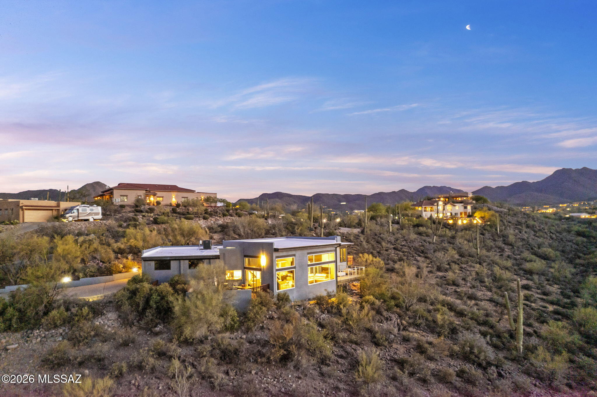 Thoughtfully updated residence featuring refined desert-modern design with panoramic views. Kitchen offers quartz countertops, matching quartz backsplash & a clean, contemporary finish. Multiple skylights with a cathedral ceiling in the great room fill the home with natural light and enhance the architectural flow. Living area showcases a 13-ft floor-to-ceiling custom tile surround framing a 58-inch three-sided Napoleon electric fireplace, updated bathrooms include custom tile, acrylic cabinetry, and quartz counters. Oversized two-car garage features a custom glass door. Close proximity to hiking & biking in Tucson Mountain Park and Saguaro National Park West; 15 minutes to Downtown and University of Arizona campus. Ideal for wildlife viewing with frequent desert species sightings.