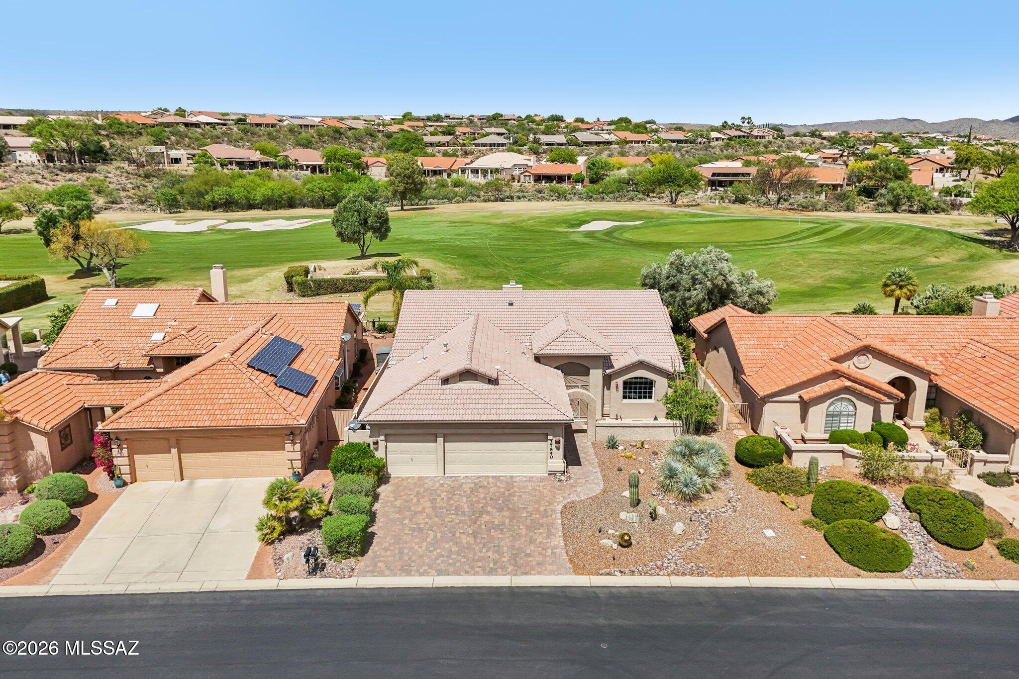 Don't miss this highly upgraded single story Galleria model situated on the 4th Green of the Tucson-Nine golf course with wonderful views.  This move-in ready home boasts a large remodeled chef's kitchen with custom Alder cabinets, granite countertops, tile backsplash and sit up bar.  New wood floors throughout, custom cabinetry, bookshelves, built-in desks in the den, and new arched window in living room.  Large oversized primary suite with sitting area, remodeled primary bath including new vanity and shower with glass door plus storage, updated hall bath and new flooring in bath and laundry. Kitchen overlooks wonderful family room with gorgeous corner style kiva gas fireplace and soft desert colors throughout.  Brick paver courtyard entrance plus wonderful extended covered patio out back with brick pavers, updated landscaping, saguaros and expansive views of the golf course and mountains.  It's the perfect spot to enjoy coffee in the mornings and relax in the evenings.  Other features include plantation shutters, wood blinds, walk-in pantry, 3 car garage, rolling outdoor shades, and brick paver driveway.  You will not be disappointed with this stunning home!