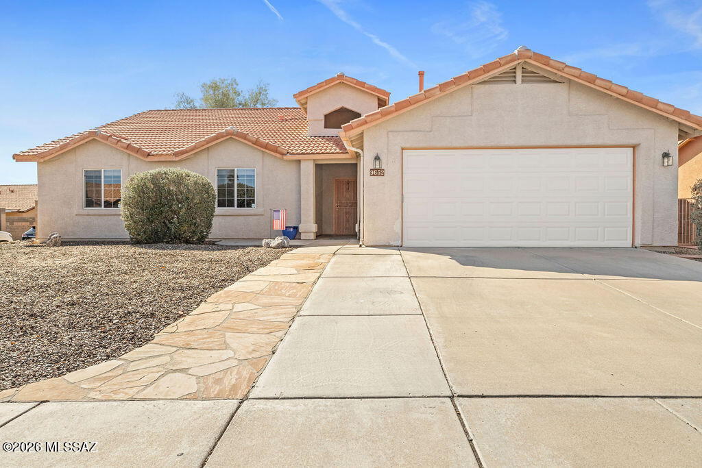 Rita Ranch home featuring 4 bedrooms and 2 baths on a corner lot in the highly sought-after Vail School District. Enjoy tile flooring throughout the main living areas, a fireplace, and a beautifully designed kitchen with rich cabinetry, granite countertops, tile backsplash, double ovens including a convection oven, a breakfast bar, and a breakfast nook with bay window. The spacious primary suite offers a bath with a separate tub/shower. Double French doors from the living room and primary bedroom open to an end-to-end covered patio for seamless indoor-outdoor living. Newer HVAC and water heater. Located near Purple Heart Park with pool, splash pad, skate park, dog park, and more. Close to shopping, dining, and everyday essentials.