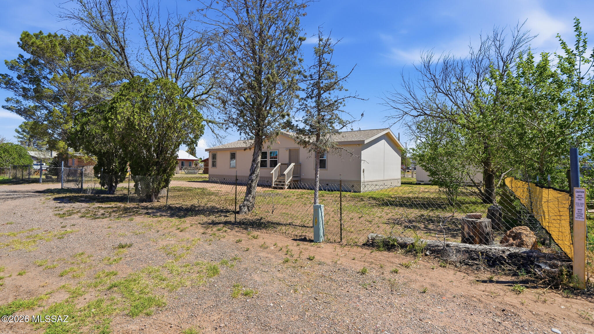 STUNNING RENOVATION!!! NEW LOWER PRICE! Almost as good as new! Home sits on approx 1/3 acre fully fenced with rear alley access. Roof replaced about a year ago. New entry steps and skirting. Entire home painted inside and out. Beautiful, updated kitchen includes spacious cabinets, Lazy Susan, slide-out pantry shelves, granite countertops. ALL appliances - including washer/dryer AND big-screen TV are INCLUDED! Bathrooms updated with new tub and corner shower, new vanities with double sinks in primary bthrm. New flooring thruout. Let's not forget 4 new windows and all new window coverings! Lots of outdoor storage. Enjoy the shade trees AND large pecan tree. Access to home is on a paved road! Home is on City water and does have gas!