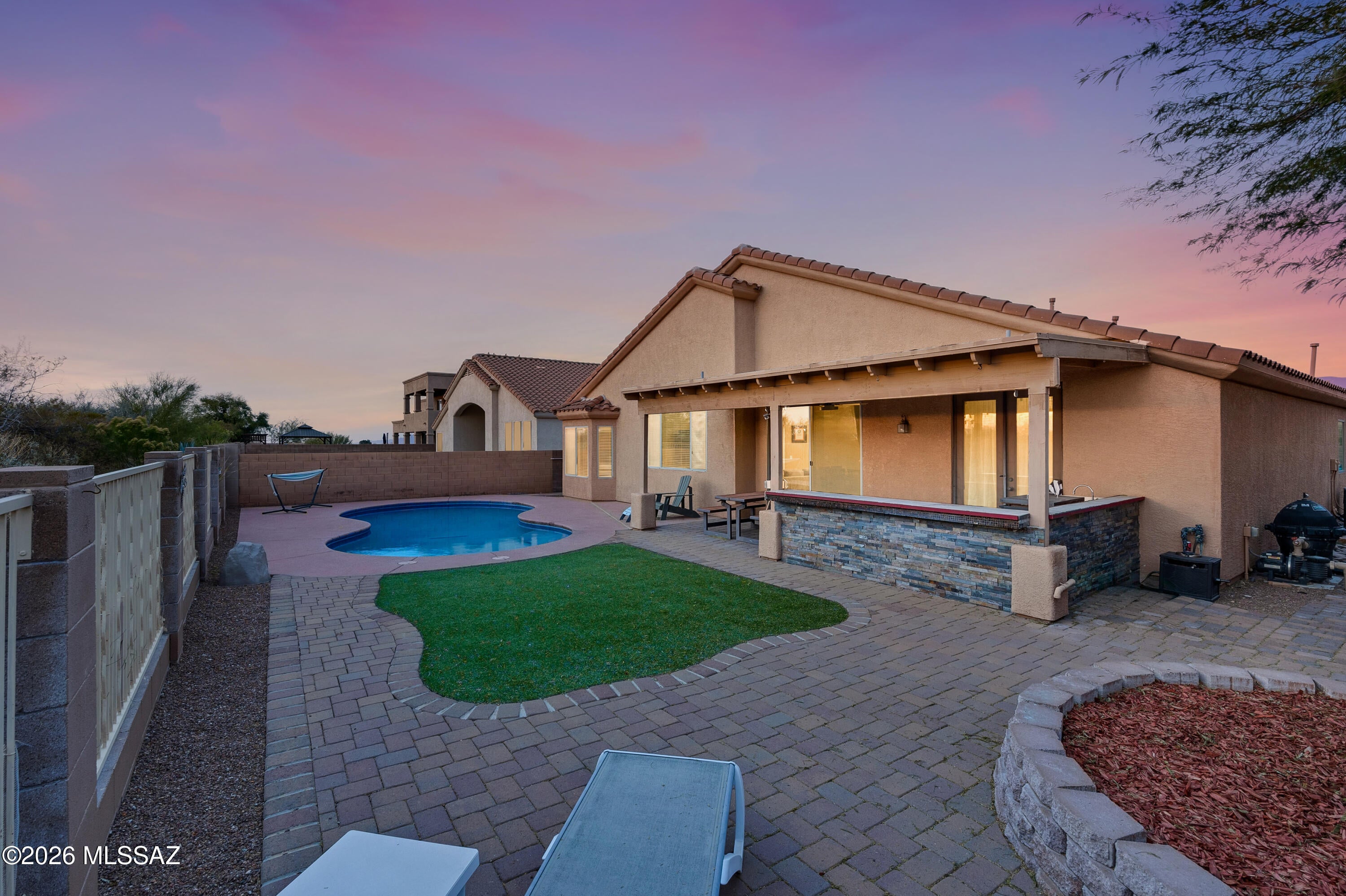 Wingview at Rancho Del Lago is a beautiful gated community in the heart of Vail and its award winning school district! Stay home and enjoy your own pool paradise or venture over to the community pool and spa and get to know your neighbors. This premium lot backs up to HOA common area with a view fence to enjoy the natural space. With extended pavers, this is a low care yard and even a little turf to enjoy. The covered patio features a built in Blackstone grill too. This floorplan features a front bedroom & bath separate from the rest of the house making a perfect multigenerational suite. With 2 generous living areas, you'll find space for whatever your lifestyle. The garage fits a full size truck plus has an EV charger. Full of opportunity, bring your ideas and make this your dream home!