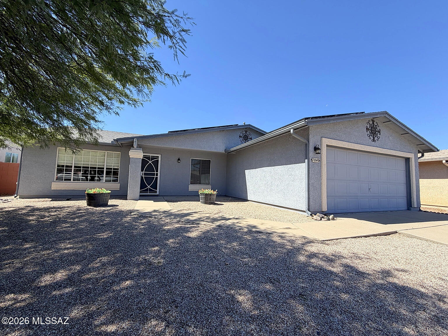 Opportunity in Rita Ranch! This 3-bedroom, 2-bath home offers approximately 1,618 sq. ft. of living space with two separate living areas and a spacious, open layout. The kitchen features abundant cabinetry, a large center island, white countertops, and a gas range. The primary suite includes a dual vanity, soaking tub, and separate shower. Enjoy the generously sized enclosed backyard featuring low-maintenance synthetic grass, extended pavers, and a covered patio. Located within the highly regarded Vail School District, near Purple Heart Park, schools, shopping, and everyday conveniences. An excellent opportunity to enjoy an established neighborhood while personalizing the home's cosmetic finishes over time. Solar panels are leased with a current monthly payment of $208.28.