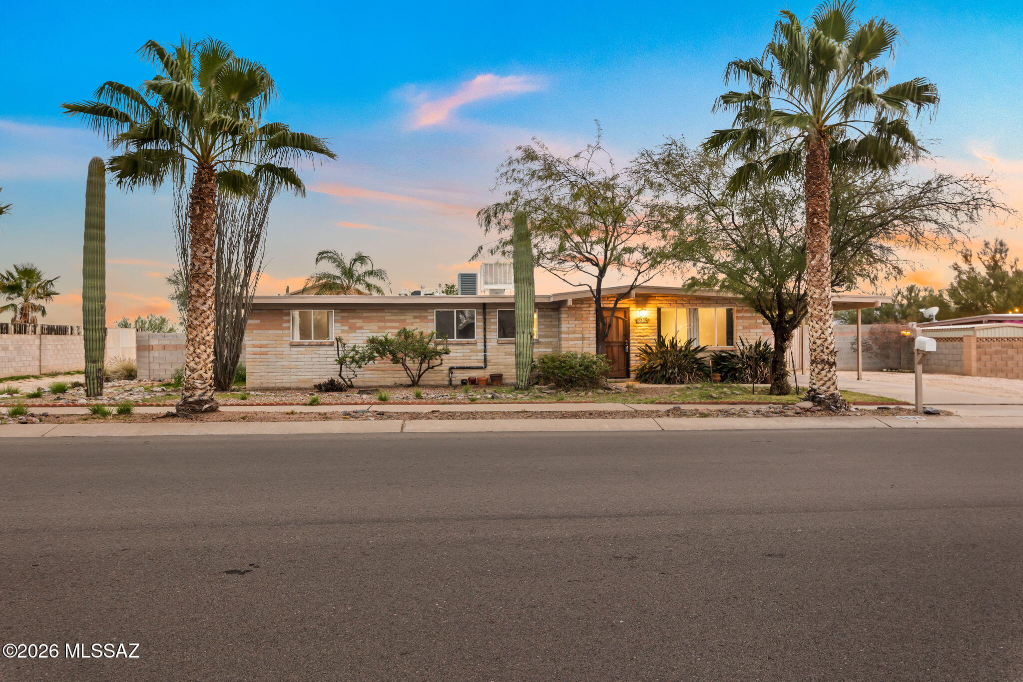 This classic home combines distinctive Tucson character, exceptional privacy, and beautiful mountain scenery. Iconic saguaros and attractive curb appeal welcome you into a spacious living room that flows into the dining area and generously sized kitchen, featuring marble-composite countertops, SS appliances, and abundant cabinetry. The flexible layout currently offers 3 bedrooms w/ the option to restore a 4th, along w/ an expansive family room ideal for a second living area, game room, office, or entertaining space. French doors open to a private backyard retreat w/ a sparkling pool, mature orange tree, and views toward the Tucson Mountains w/ glimpses of the Catalinas. With only one direct neighbor, the property offers a peaceful, secluded feel while remaining convenient to amenities.