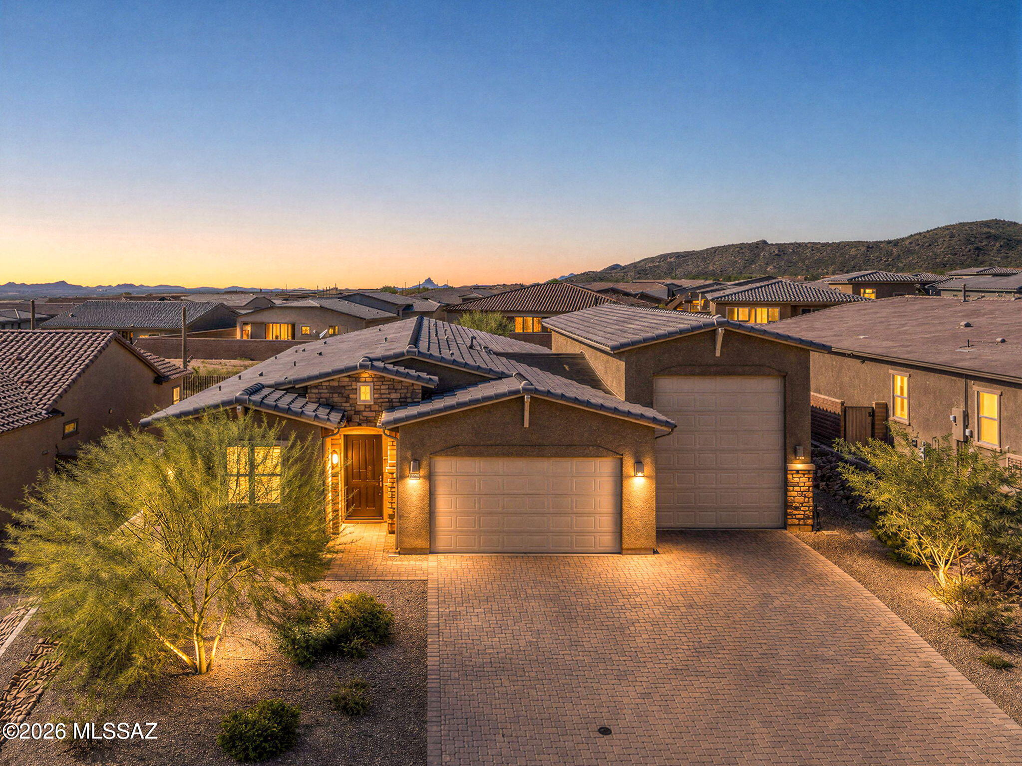 Looking for newer construction with a 47' RV garage and all the finishing touches already done? This beautiful 2023-built home is tucked inside the gated Los Saguaros community at Dove Mountain, nestled against the Tortolita Mountains. The thoughtfully designed 4 bed, 2.5 bath split floor plan opens with a spacious entry leading to the guest wing and into an impressive open-concept great room. At the heart of the home is a stunning kitchen featuring a massive island, quartz counters, glass tile backsplash, upgraded cabinetry with crown molding, pendant lighting, SS appliances, gas cooktop and double ovens. A large dining area provides plenty of room for gatherings and flows seamlessly into the living space, where center-meet sliding doors open to the beautifully finished backyard with turf , pavers, decorative gravel and peek-a-boo mountain and sunset views.

The spacious owner's suite features a large walk-in closet and ensuite with dual vanity, quartz counters and an oversized tiled shower. French doors and a walk-in closet make the 4th bedroom an ideal office, den or flex space.

But the showstopper may be the garage! In addition to the 2+ car garage, an attached RV garage measuring approximately 47' deep x 15' wide x 16' high with a 14' high x 12' wide garage door, allows for serious room for your RV, toys, vehicles, workshop or storage. Combined with the epoxy floors, insulated garage doors, an added subpanel with 220V EV charging capability and a 50-amp RV plug, this is garage space that's hard to find!

Additional upgrades include a whole-home water filtration system, tankless water heater, Ring doorbell, keyless entry, upgraded ceiling fans and wood-look tile throughout the main living areas. Enjoy the benefits of a newer home without waiting on construction or spending the time and money adding landscaping and finishing touches after closing. This one is truly move-in ready!