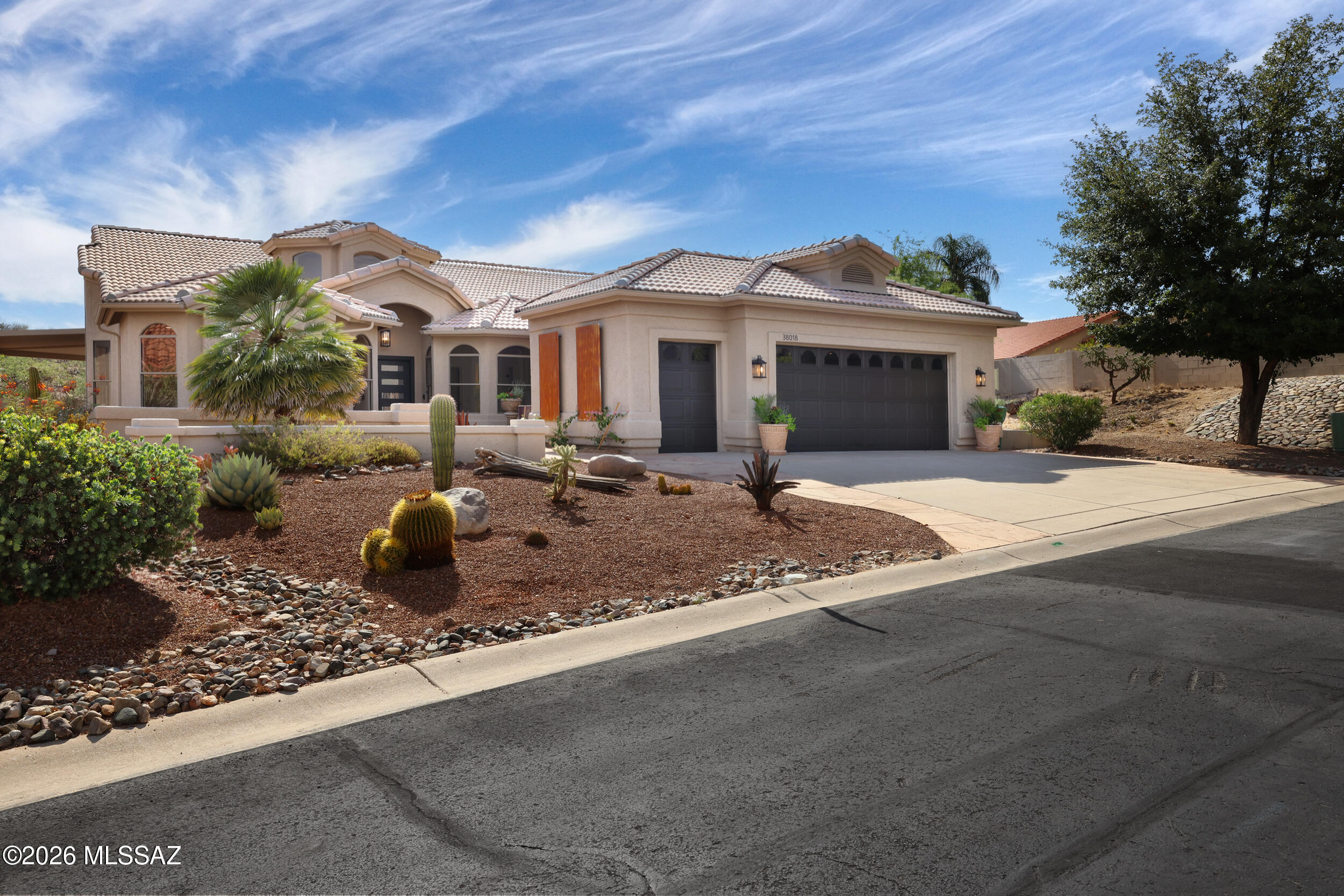 Perched atop the highest point on Desert Bluff Drive, this beautifully remodeled 2,750 SQ FT Cambria model masterpiece captures the sweeping Catalina Mountains and enchanting desert views with unmatched privacy-only one neighbor on one side and wildlife open space behind. A grand entryway sets the tone for the home's elevated design. This 3BR/3.5BA residence features an oversized primary suite with a private seating area, plus two additional guest suites, along with a dedicated office/bonus room, & spacious dining room ideal for your holiday celebrations. Soaring ceilings and abundant natural light flow throughout, enhanced by new care-free upkeep concrete overlay flooring for a seamless modern feel. At the heart of the home, the gourmet designer chef's kitchen showcases luxury high-end appliances, custom cabinetry, a large walk-in pantry, and expansive counters designed for effortless entertaining and gatherings.

Enjoy sunrise coffee on the east-facing front patio or host unforgettable evenings on the oversized southwest patio with an extended pavilion and Catalina views. Owned solar, new dual HVAC, instant hot water, new roof underlayment, post-tension foundation, spa connection out back and 2-car garage with space for two golf carts, complete this exceptional Saddlebrooke retreat.
