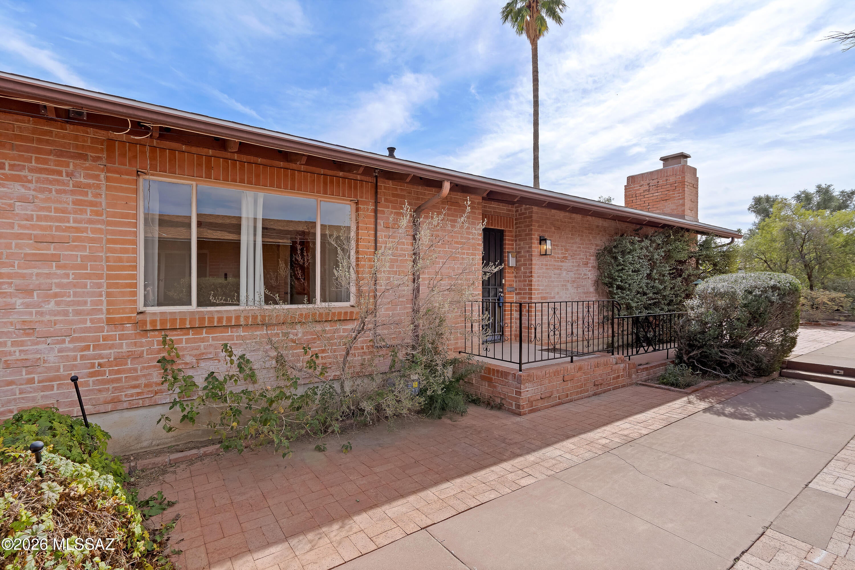 An ideal central location near U of A! Charming mid century brick home set among the historic Miramonte neighborhood, right around the corner to the 3rd St bike path, Whole Foods, Starbucks, La Rosa/Sisters, and plenty of restaurants and amenities! Features include inviting living room with fireplace, built in shelving w/panel to hide TV wiring, gas range in kitchen, dining area with parquet flooring, tile floors (no carpet!), large glass slider door to covered, brick paved patio that opens to lovely front yard. Primary bedroom with private patio, full bath, and spacious closet, stackable washer/dryer included, tankless water heater, storage shed, and additional parking in alley. Roof warranty in place until Dec 2026 with Spencer Roofing!