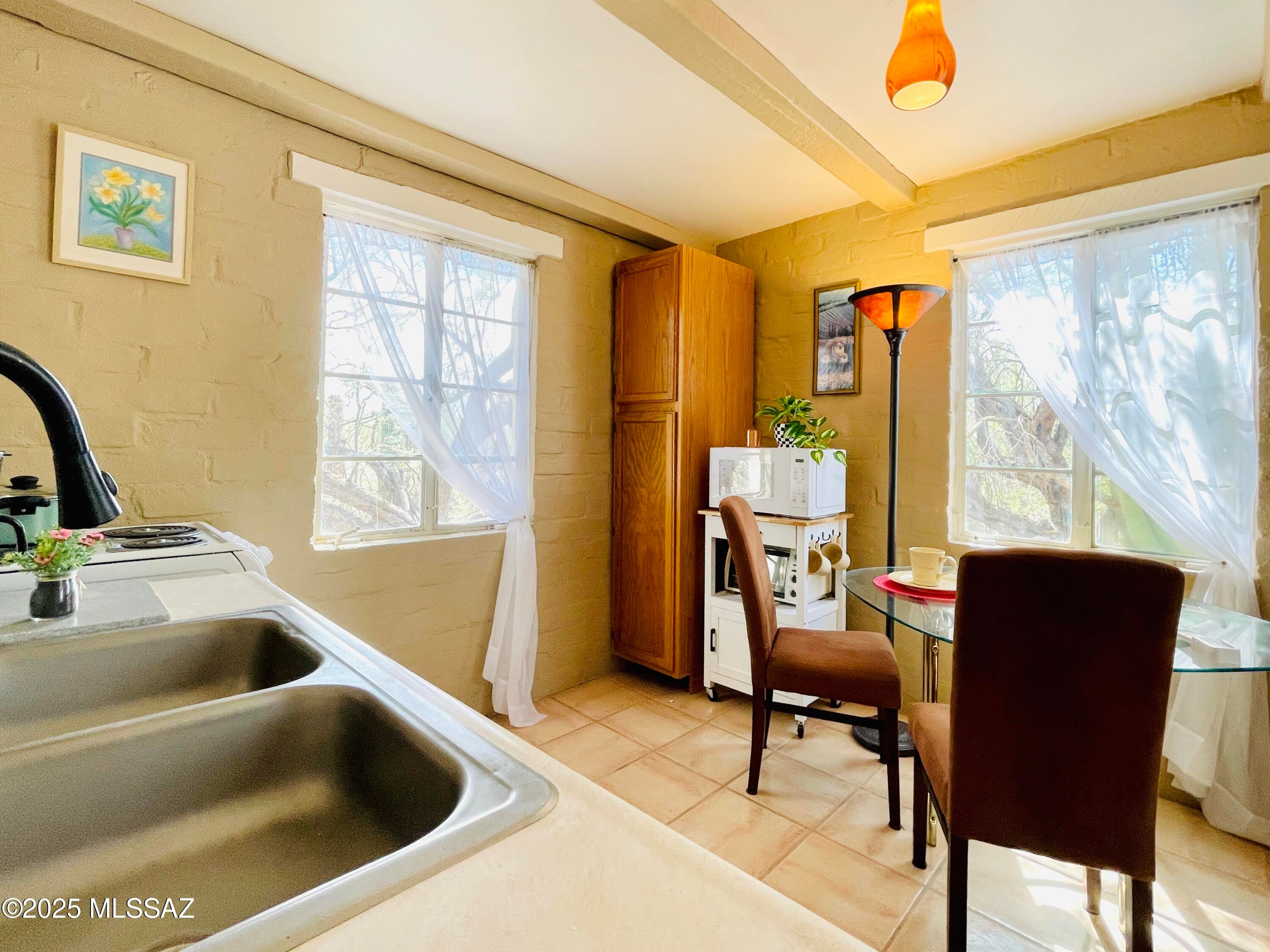 GUESTHOUSE - fully furnished with private entry in a beautiful and natural environment, special and charming on 2.5 acres, separate and cheerful kitchen/dining area, spacious great room/bedroom studio plan with picture window. Your GUESTHOUSE is complete with all furnishings including dishes and has a tasteful style from suede dining chairs and accent lighting to a matching highrise headboard. Sparkling pool shared with main house. Mountain views, a colorful sunset, and amazing nature, yet close to everything. -Fabulous lease of 6 months or longer with all utilities, including wifi, basic cable, and shared w/d room. This guest house is an enjoyable place! *EMS Realty represents the Landlord only on this listing.*