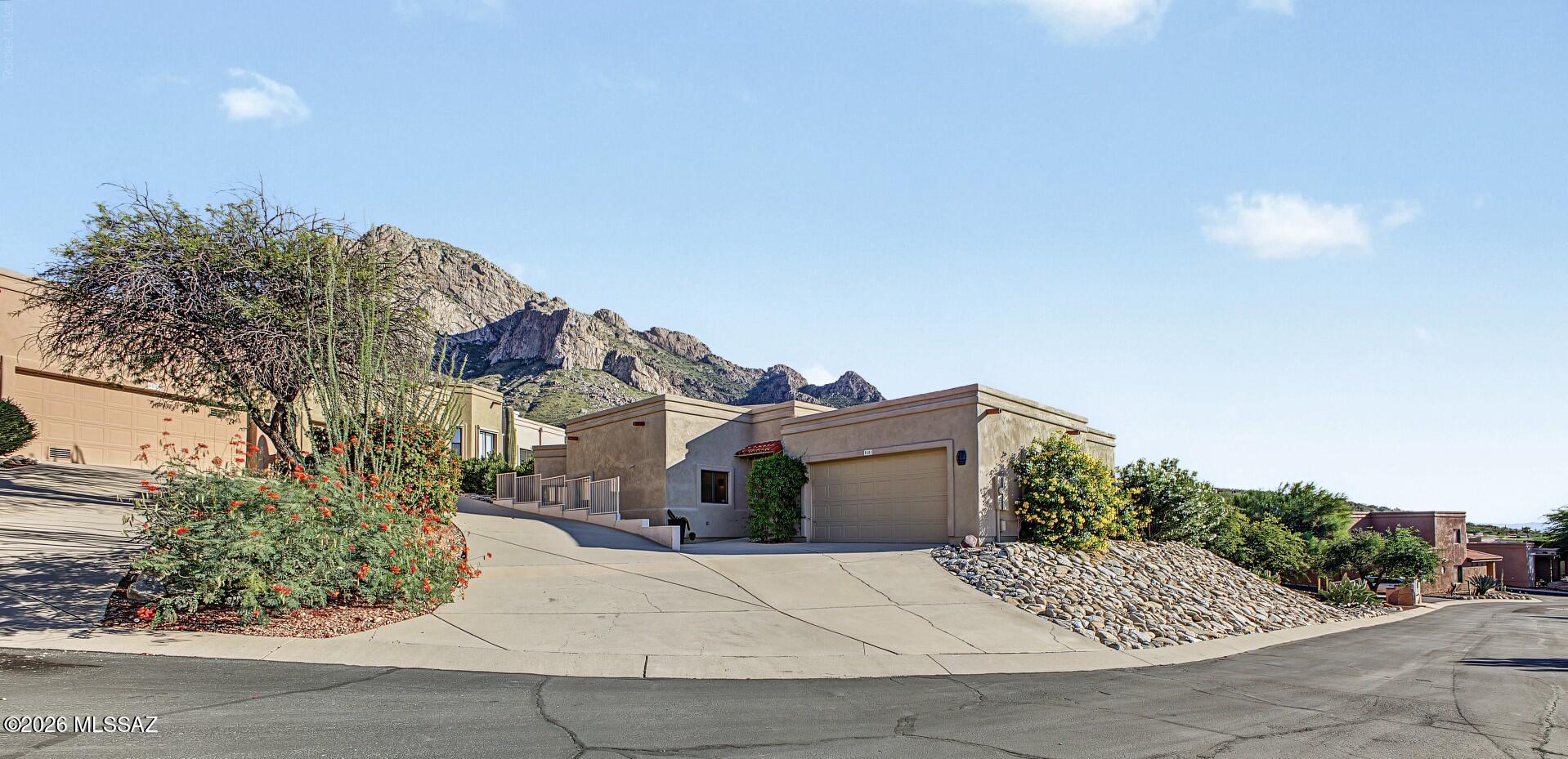 LOCATION, LOCATION, LOCATION! Situated on a premier ridgetop at the end of a secluded cul-de-sac, this exceptional semi-custom townhome captures sweeping, views of Push Ridge and the sparkling cityscape below offering a rare blend of serenity, privacy, and scenic beauty.

Thoughtfully designed interior, this home features 1924 sq ft,  3-bedrooms, 2-bathrooms, a 2-car garage, and dual private patios embodies timeless Southwestern elegance with modern refinement. The expansive living room offers dramatic Douglas fir beams and a statement beehive fireplace, creating an inviting yet sophisticated atmosphere ideal for both intimate gatherings and elevated entertaining.

The kitchen is beautifully appointed with granite countertops, stainless steel appliances, and a generous peninsula with bar seating- perfectly positioned to flow into the dining and living spaces for a seamless open-concept experience. Rich tile flooring enhances the main living areas, complementing the home's warm and cohesive design.

The primary suite serves as a private sanctuary, featuring direct patio access with breathtaking views, tile flooring, and a spa-inspired ensuite complete with dual vanities, a soaking tub, and a separate glass-enclosed shower.

The guest accommodation includes a secondary bedroom with its own private patio- an ideal retreat for entertaining friends & family. A well-situated interior laundry room adds convenience, with washer and dryer included.

Ideally located in the heart of Oro Valley, this townhome offers close proximity to upscale dining, boutique shopping, premier golf courses, and an abundance of outdoor recreation including hiking, biking, and scenic walking paths. This truly is a gem!