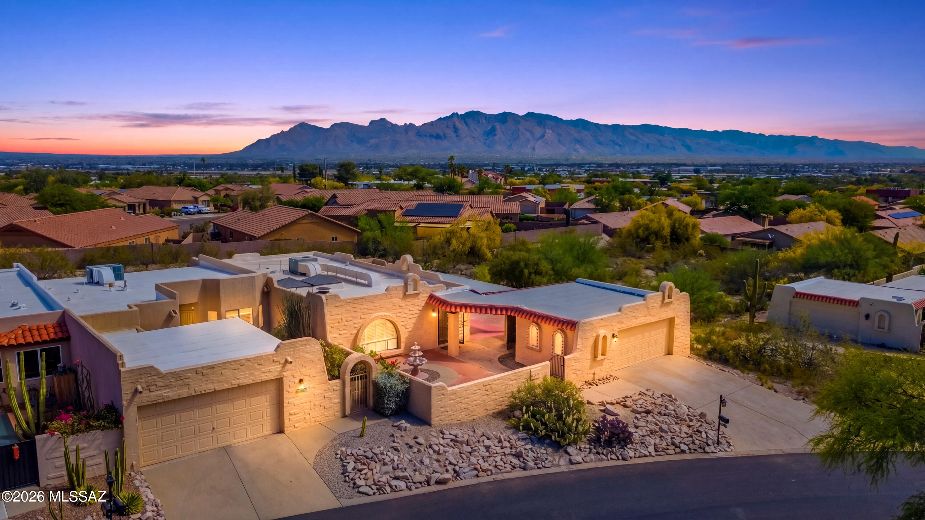 Corner and on an elevated lot, this 3 bedroom 2 bath townhome on the west side of Tucson has a functional layout with great mountain views. Highlighting features include Saltillo tile floor throughout, honeycomb fireplace in the living area, and consistent natural lighting. The property welcomes you with its own private courtyard with fountain, a central atrium with a skylight that adds flexible interior space, and a large covered patio that extends the living area outdoors. Two car garage and end unit placement provide additional privacy and separation compared to typical townhome layouts. Conveniently located with easy access to downtown, I-10 freeway, Pima West Campus, St Marys hospital and plenty of hiking trails, this home offers both tranquility and connectivity.