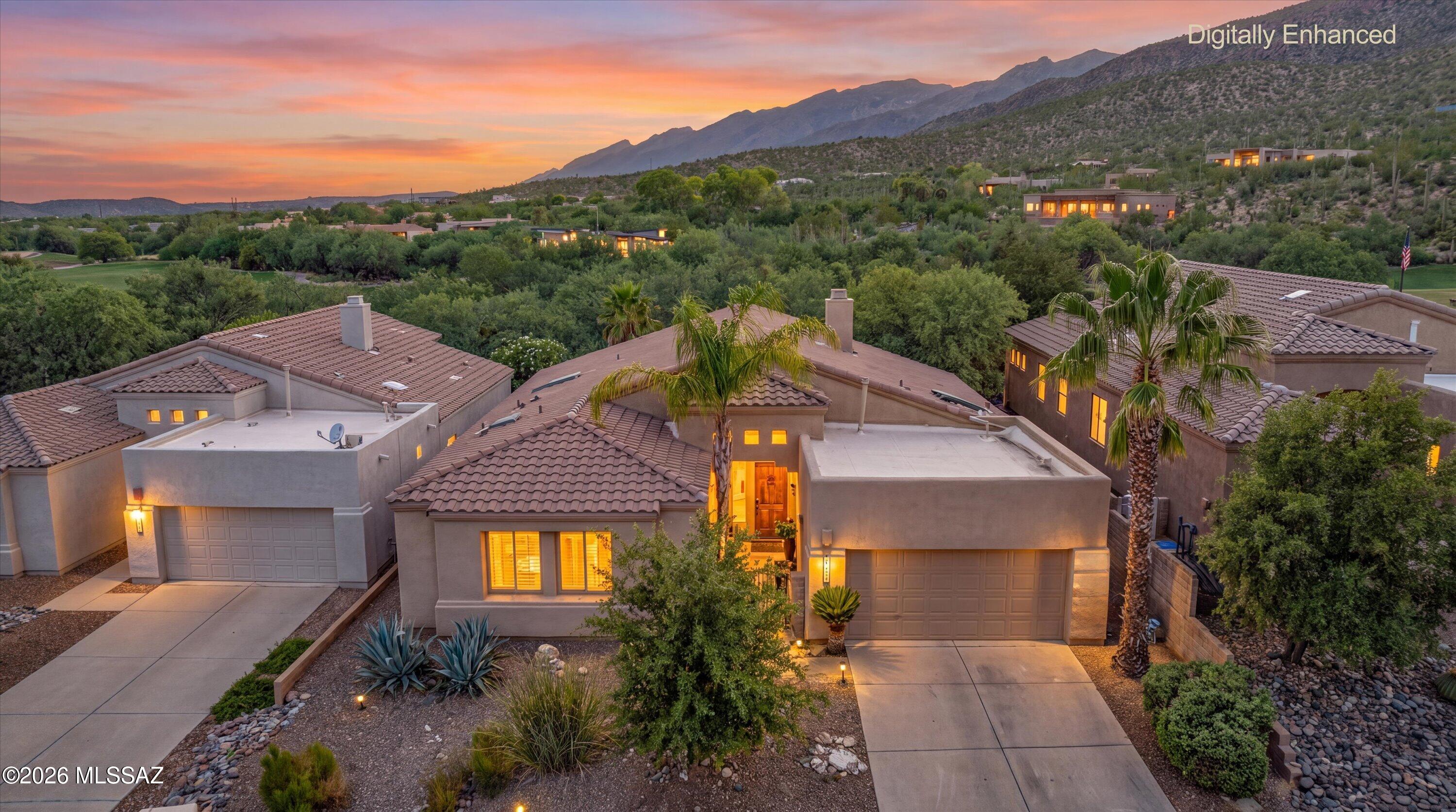 *BUYER INCENTIVE*Sellers are offering $14,000 toward a buyer's interest rate buydown or closing costs with an acceptable offer! Tucked into a beautifully landscaped setting with Catalina Mountain views, this 3 bedroom, 2 bath home with a separate den offers the indoor/outdoor lifestyle Tucson does best. High ceilings, natural light & tile flooring create an inviting interior. The living room features a fireplace with built in shelving & flows into the dining area & updated kitchen with granite counters, stainless appliances, gas cooktop & microwave & wall oven. Spacious primary suite offers patio access, dual vanities, soaking tub & separate shower. Outside, enjoy a private backyard retreat with a sparkling pool, rock waterfall, mature landscaping & covered patio. In gated Sabino Springs