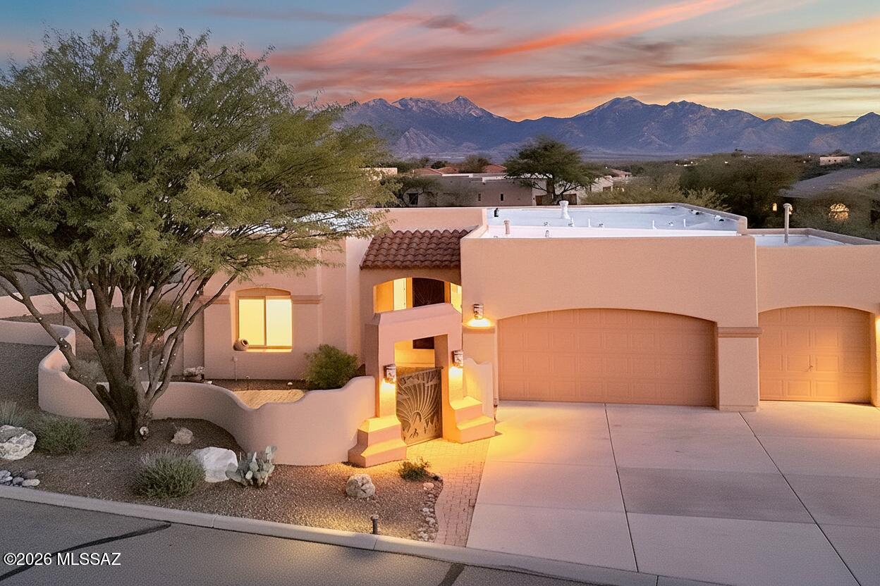 Nestled in the heart of Southern Arizona's magnificent high desert, this stunning estate offers an extraordinary canvas for the life you've been imagining--where every day feels like a celebration of natural beauty, cherished connections, and the art of gracious living. The property's dramatic setting is nothing short of breathtaking.  The Santa Rita Mountains paint an ever-changing backdrop from the outdoor living spaces.  The welcoming front courtyard sets the tone for your home's gracious hospitality, while the expansive rear patio becomes your private resort. Gather friends around the built-in fire pit for intimate evening conversations under the stars, or fire up the grill in the outdoor kitchen for unforgettable alfresco dining as the sun sets over the mountains.  The heart of the home is a magnificent great room with soaring ceilings, featuring sliding doors that, when opened, create a seamless, flowing space perfect for entertaining. 
The kitchen stands as the culinary centerpiece you've always wanted, magnificent in both form and function, with a generous center island that naturally draws people in. Flow effortlessly from food preparation to the intimate breakfast nook for morning coffee, or host formal celebrations in the elegant dining area where mountain views become part of the table setting.  The home's soaring ceilings create a sense of openness and light throughout, while distinct spaces offer opportunities for every aspect of life. Curl up in the cozy den, tackle projects in comfort, or simply enjoy a quiet afternoon with a book. The grand primary suite is your personal retreat, overlooking the patio and views beyond, with a spa-like bath designed for relaxation and rejuvenation. A private guest suite with its own bath ensures visitors feel pampered and comfortable during their stay. A 2nd guest room is ready for guest overflow. This impressive estate isn't just a house, it's an invitation to live with intention, beauty, and ease. Your next chapter begins here. (NEW ROOF AND HVAC!)