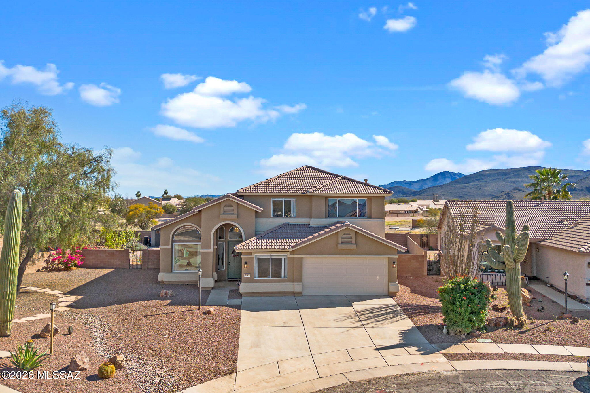 Sitting in a cul de sac on a pie shaped lot with open space behind and open views of Sombrero Peak. 7767 W Bodie Rd offers a great layout and spacious yard, close to neighborhood amenities. An owned solar system brings in an element of sustainability and transfers to the new owner at no cost. This home features 5 bedrooms & 3 full bathrooms, allowing for a variety of use possibilities. On the lower level, you will find soaring ceilings and two spacious living areas, plus the primary suite, 1 guest bedroom + 1 full guest bath.  The upper level includes 3 guest bedrooms, a full guest bathroom and small loft. Recently, the kitchen has been refreshed with painted cabinets, quartz counters, a bright backsplash and built-in seating. All baths have been modernized with light-painted cabinetry, while the primary shower was completely redone. A newer roof and systems are excellent benefits to future residents.

Outside, the huge backyard has been finished with small stones (easy underfoot for walking + playing). A desert orchard has been created on the north end, including peach, apple, plum, grapefruit, lemon, mulberry and grapevines-- all fully irrigated.  Ample space remains to make other additions.

The convenience of this location can't be beat. Twin Peaks K-8 is essentially next door to the west (walkable). Just east sits Windmill Park, exclusive to neighborhood residents, and includes a playground, swimming pool & spa, ramadas, large grassy areas and a ball field.  Within 1 mile, there is a grocery store, pharmacy, veterinary services, restaurants, a gym and auto service. From this location it's easy to access I-10 for community to any of the area's major employers.