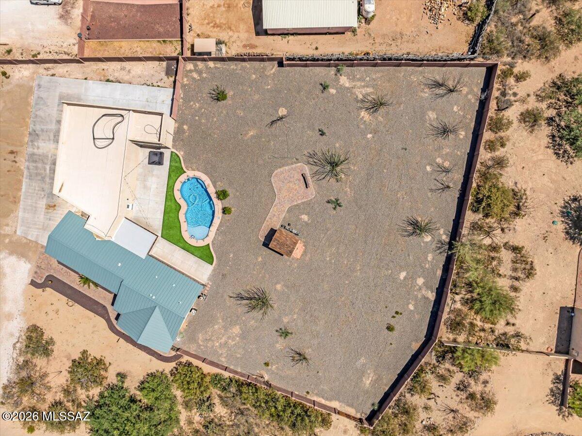 Rare New Tucson find-no HOA and horse property on a corner lot with mountain views! This home offers 3 bedrooms/2 baths with a bonus room/office off the garage.  An open floor plan, quartz countertops, newer stainless-steel appliances with convection oven, and diagonally laid tile throughout (carpet in den/bonus rooms). Enjoy a 2019 built pool and above-ground spa. Massive deep garage fits 6-8 vehicles with 220V and bult-up roof reinforced 14'' on center for future deck or solar. Just to the side of the garage is an RV pad with 50 amp. In 2020 a 24=gauge steel roof was installed and full gutters.