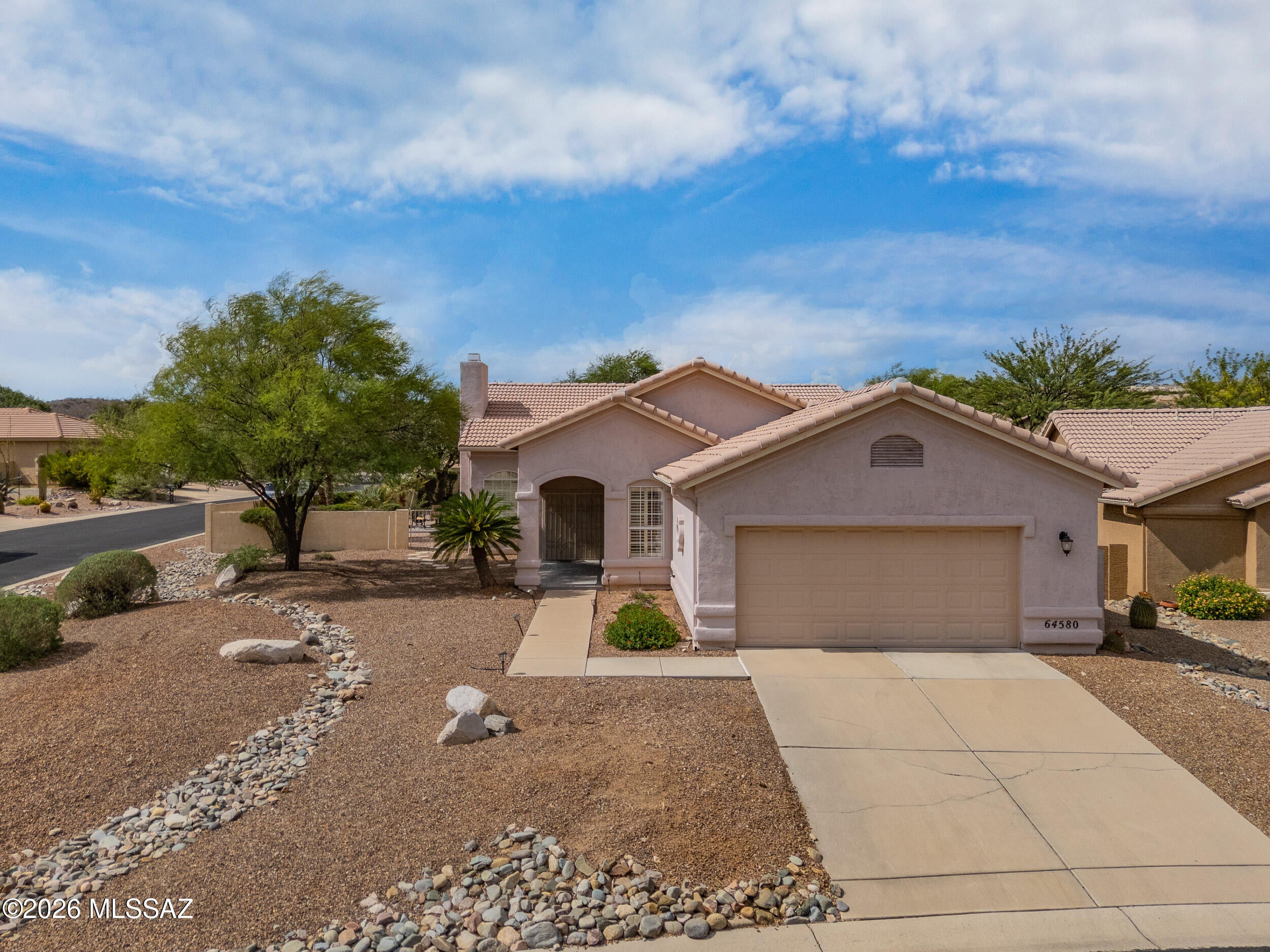 Welcome home!!  Beautiful Fiesta model in HOA 1.  This is a 2 bedroom plus den floor plan with 19inch tile throughout. The kitchen is equipped with stainless steel appliances, a 5 burner gas cooktop and slab granite countertops.  Relax in the beautiful backyard with fountain and covered patio. Enjoy the gas fireplace in the living room on the chilly days and the lovely mountain views year round. Don't miss this one!