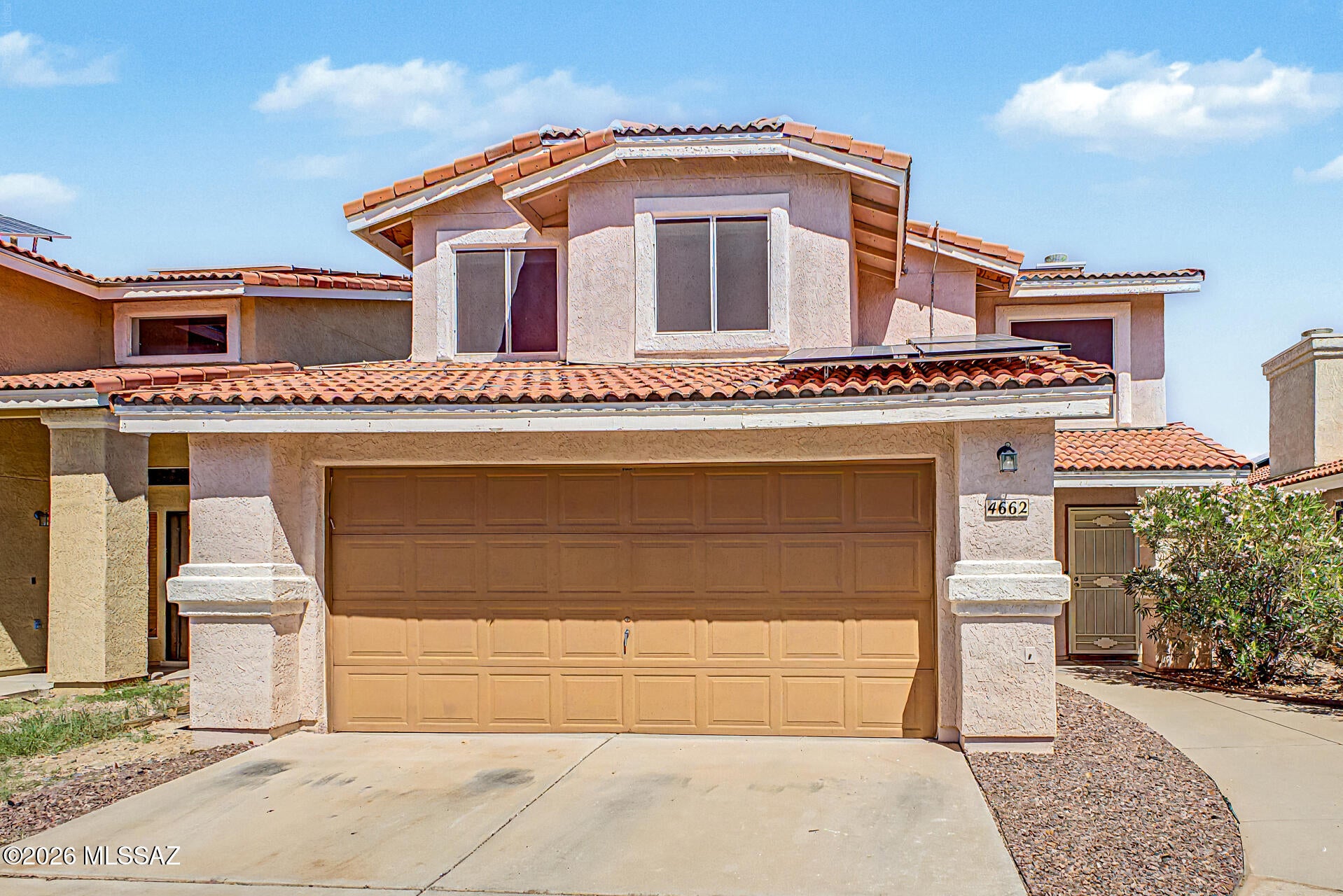 Updated, move in ready, and packed with value! This two story, 3 bedroom, 2.5 bath home features soaring vaulted ceilings, wood-plank ceramic tile, a new A/C, and a newer roof. Large windows drench the living room in natural light, while a corner fireplace creates an inviting focal point. The spacious, beautifully landscaped backyard features low-maintenance turf, plenty of room to entertain or unwind, and a separate dog run. Enjoy an affordable HOA with access to the community pool. Come see it today!