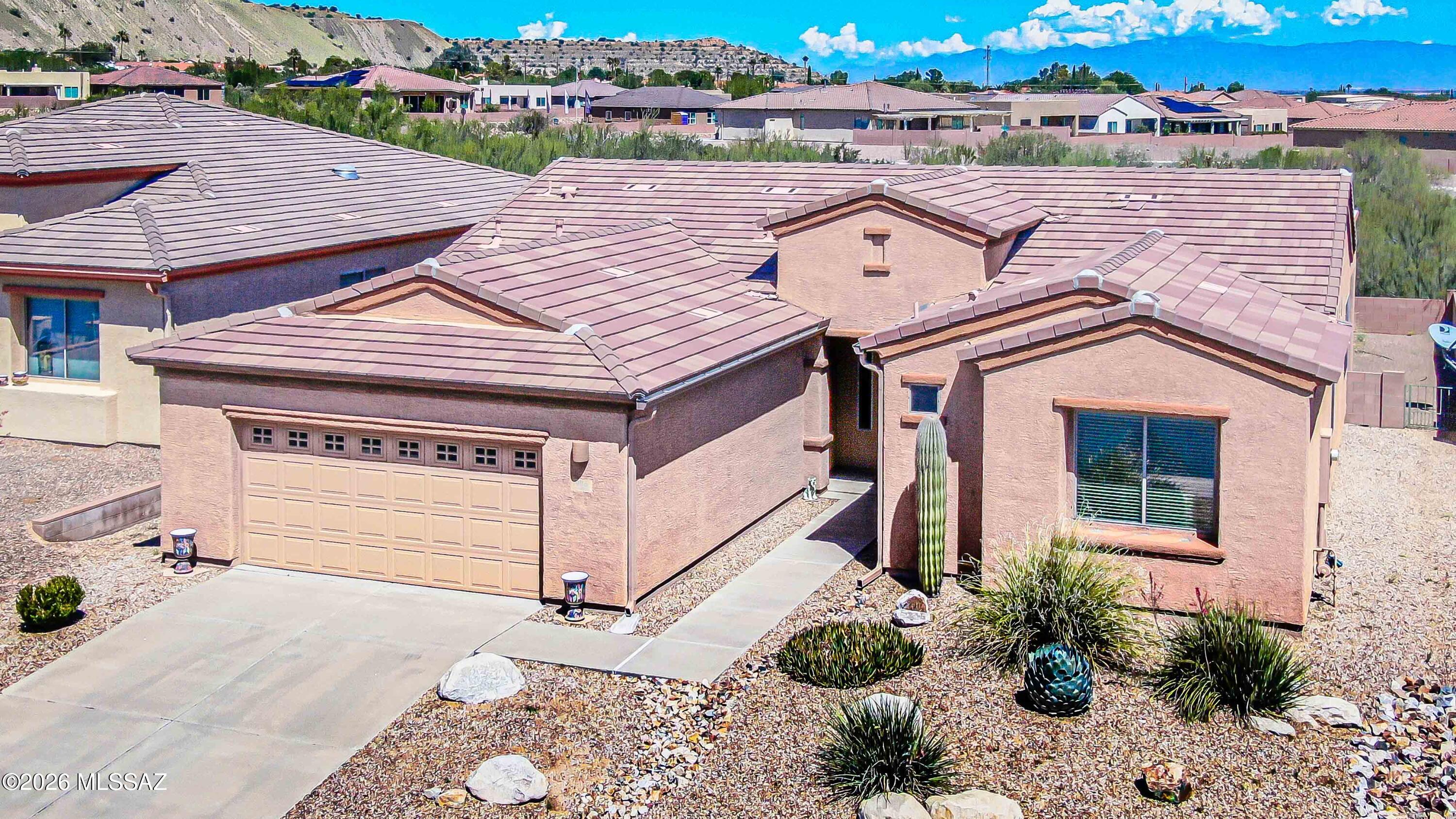 Beautifully maintained Las Campanas home in a sought-after 55+ community! This open, light-filled Great Room floor plan offers 2 bedrooms, 2 baths, a versatile den, a laundry room, and an oversized 2-car garage. Enjoy tile and carpet flooring, granite countertops, oak cabinetry, a cozy beehive fireplace, and ceiling fans throughout. The private back patio backs to natural desert HOA common area, creating a serene setting perfect for outdoor entertaining and relaxing. Thoughtfully appointed and move-in ready, this home offers comfortable, low-maintenance living. All furniture and personal property included with Bill of Sale. A rare find -- must see to truly appreciate!